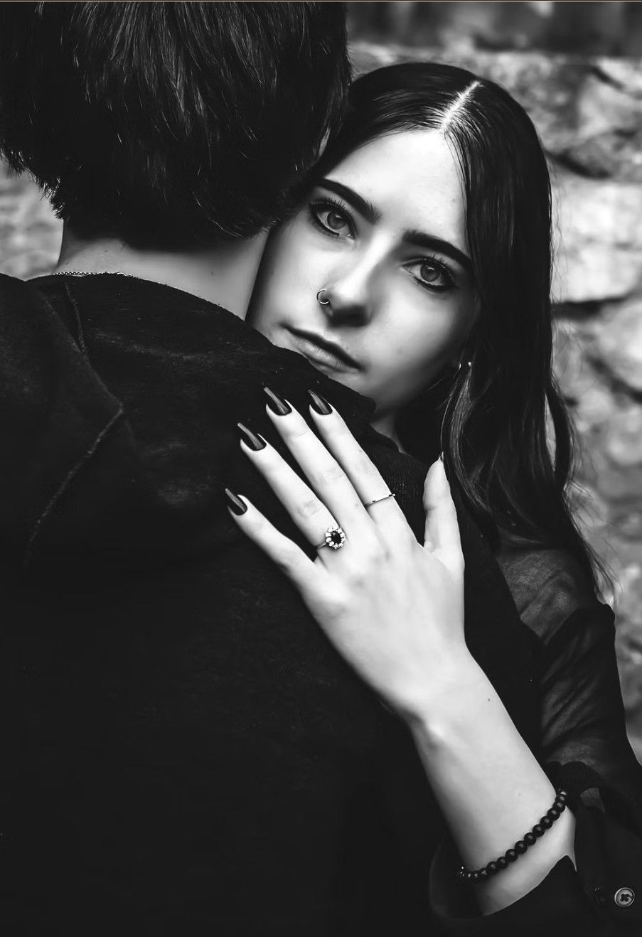 Dramatic black and white portrait series showing close-up details of dark hair, rings, and hands in a moody artistic style.