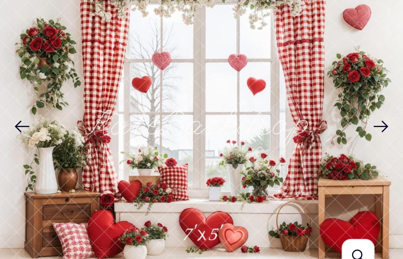 Romantic Valentine's Day window display with red gingham curtains, heart decorations, and potted flowers on wooden crates.