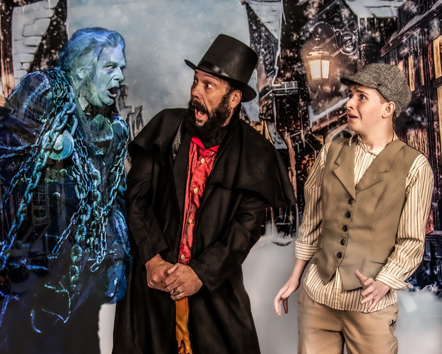 Two performers in western costumes interact dramatically on stage against a dark background.