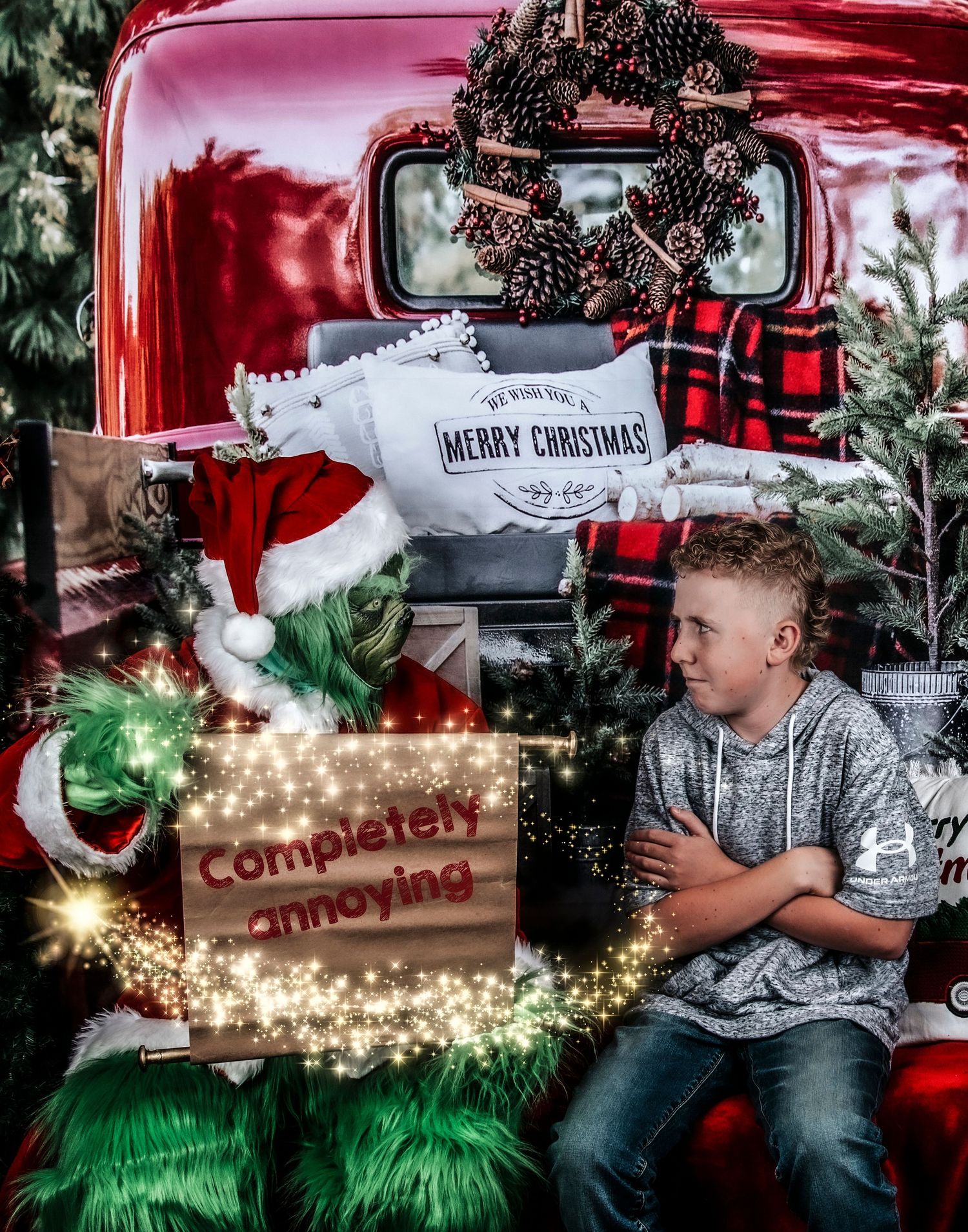 A vintage red truck decorated with Christmas greenery and twinkling lights creates a festive holiday scene.