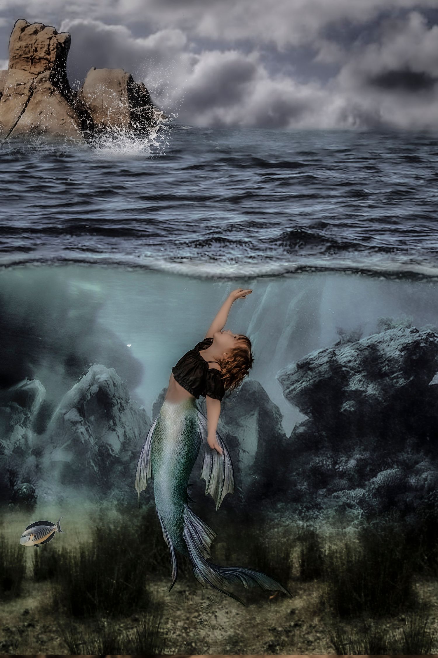 Underwater fantasy scene of a mermaid swimming in stormy seas near rocky cliffs.