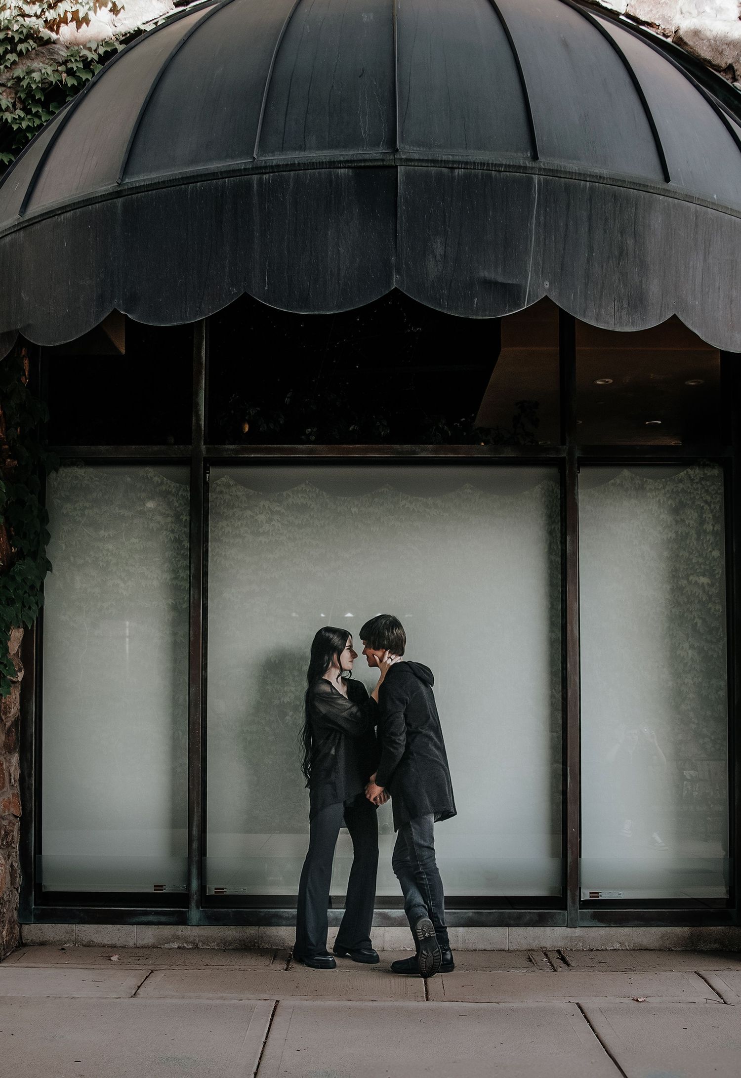 Series of architectural shots showing black awning over storefront windows.