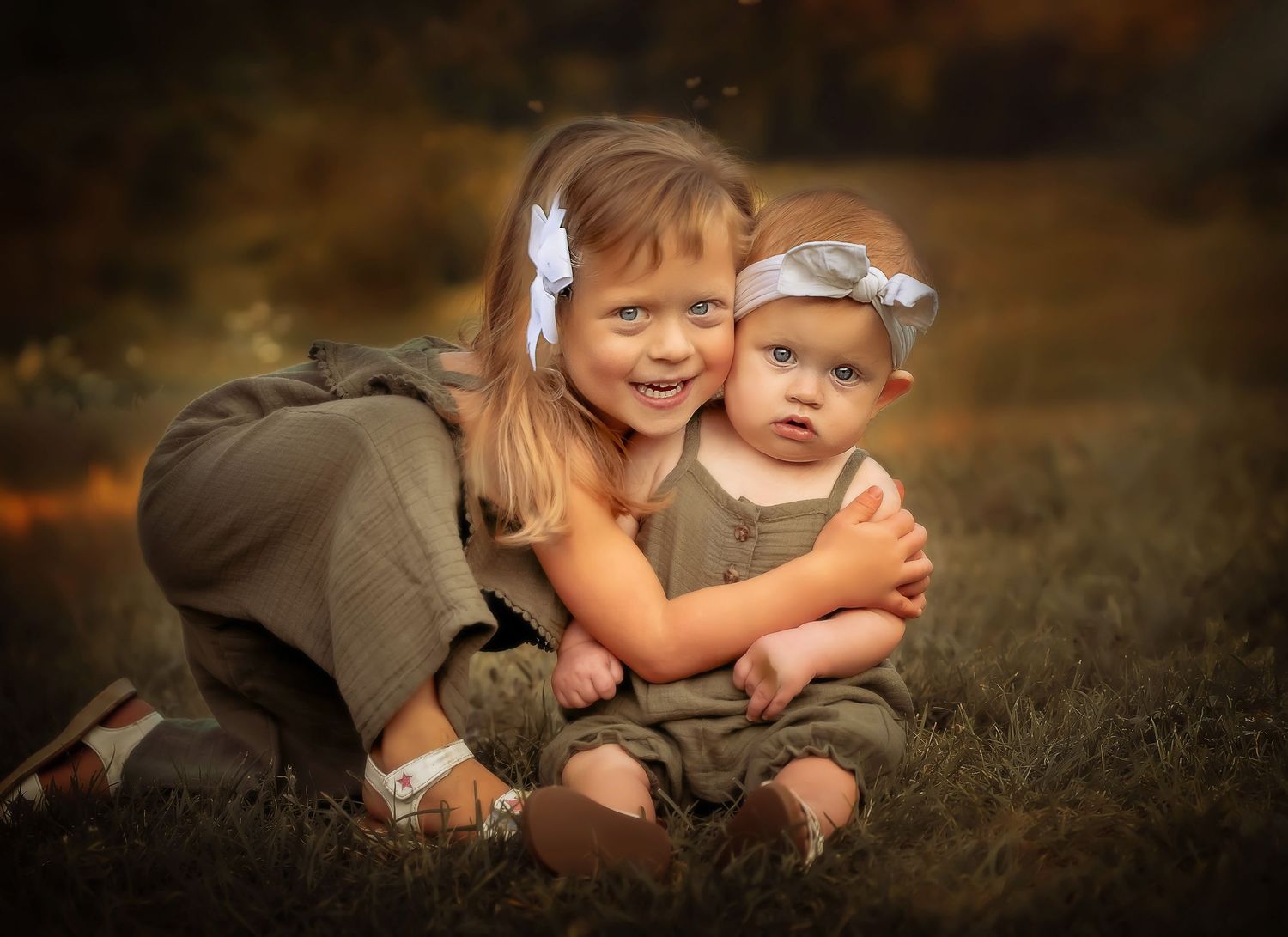 Two small children share a joyful moment together in an autumn field.