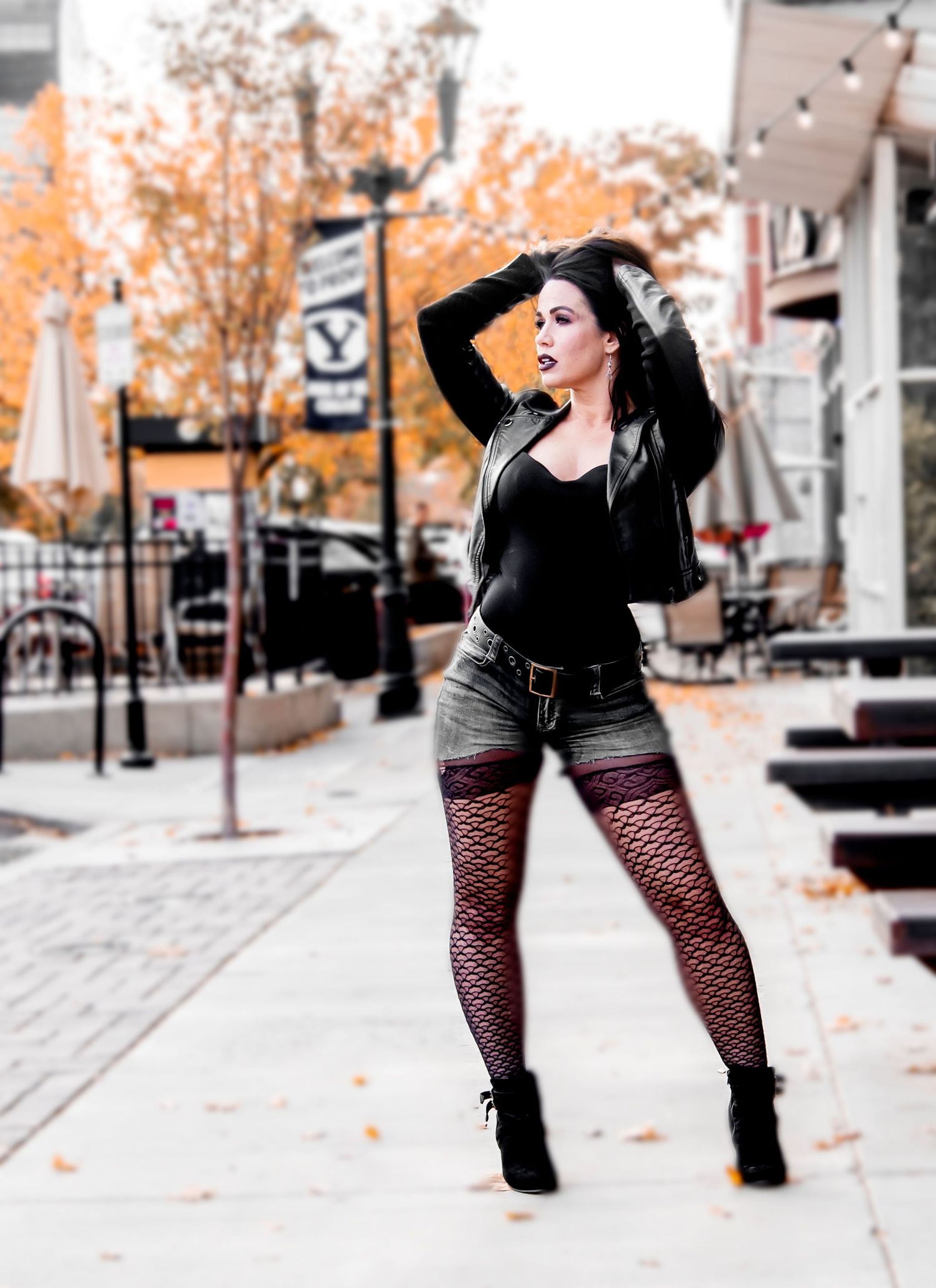 Street fashion photo with autumn colors featuring edgy style and urban backdrop.