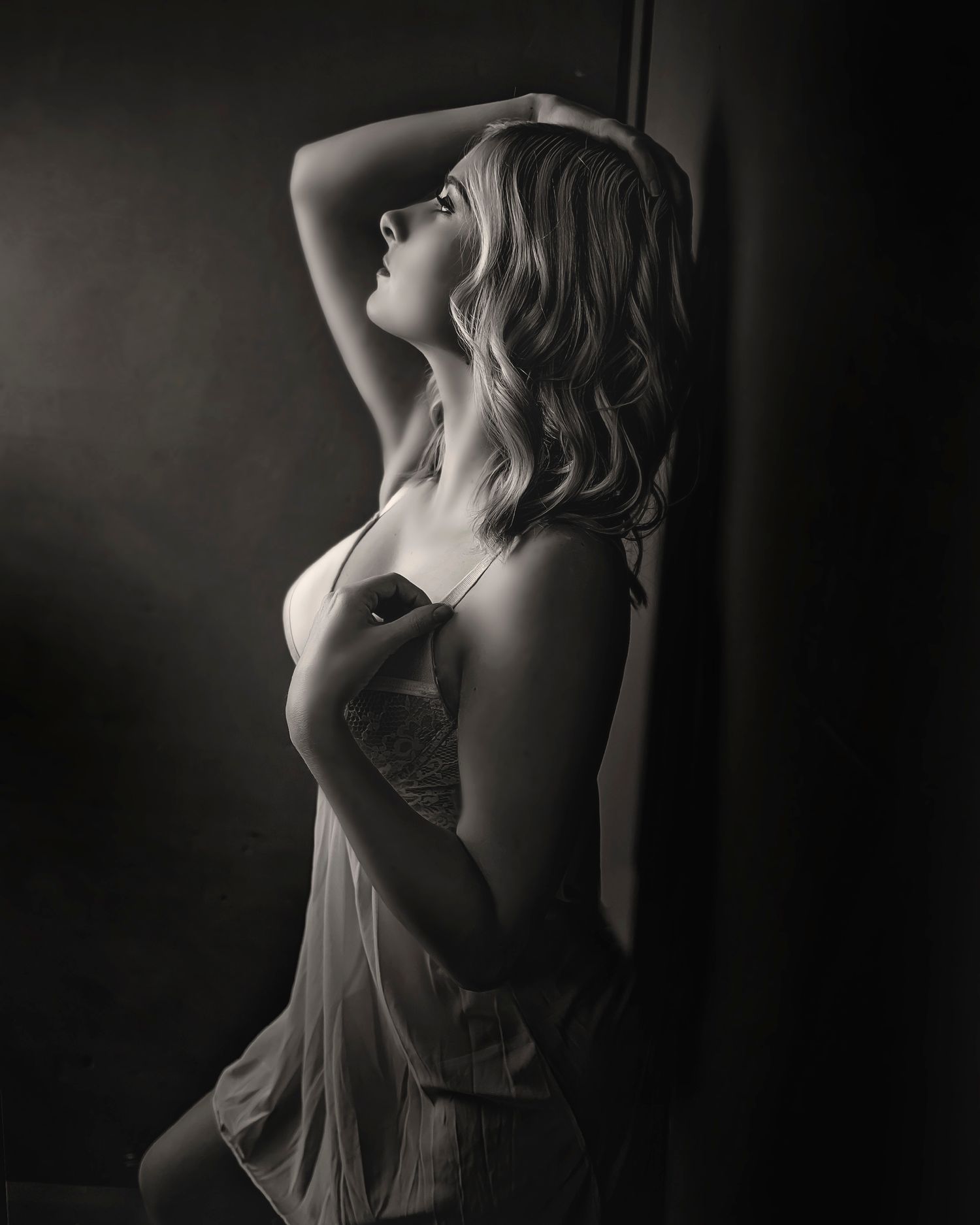 Artistic black and white silhouette portrait in dramatic lighting.