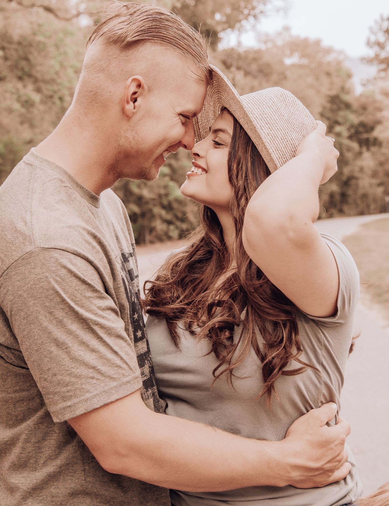 Couple shares intimate moment while wearing matching neutral tones.