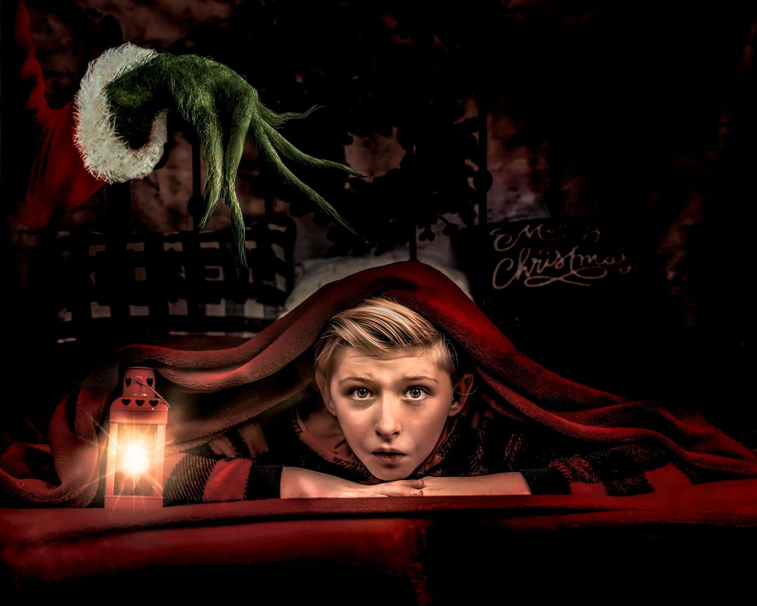 Moody Christmas themed photo with lantern light and red blanket in dark setting.