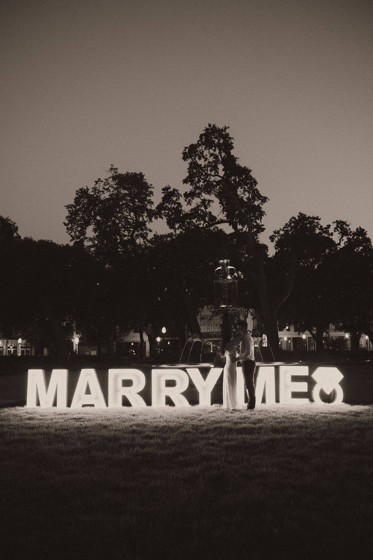 Couple celebrating a surprise proposal in Downtown Mobile, Alabama