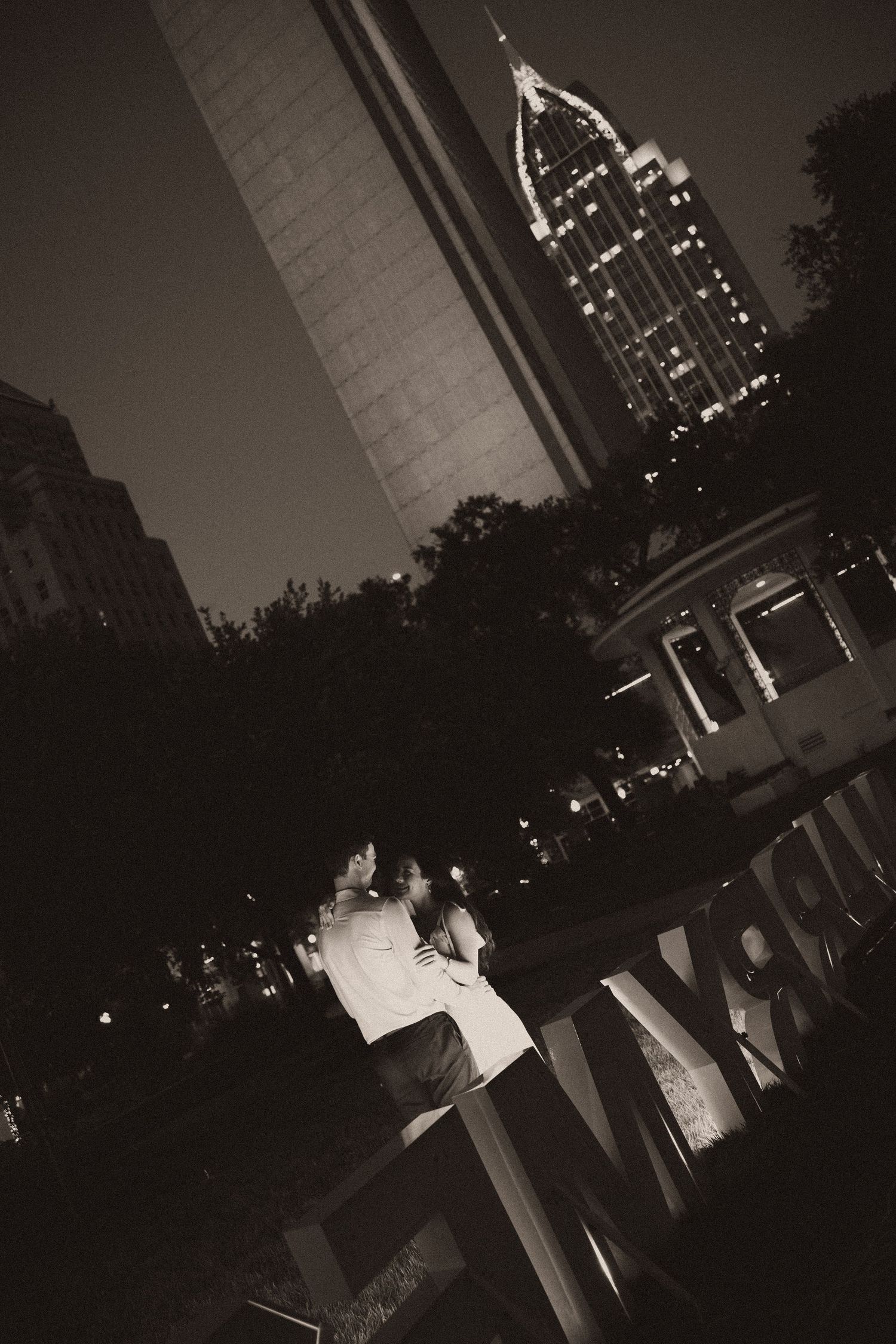 Couple celebrating a surprise proposal in Downtown Mobile, Alabama