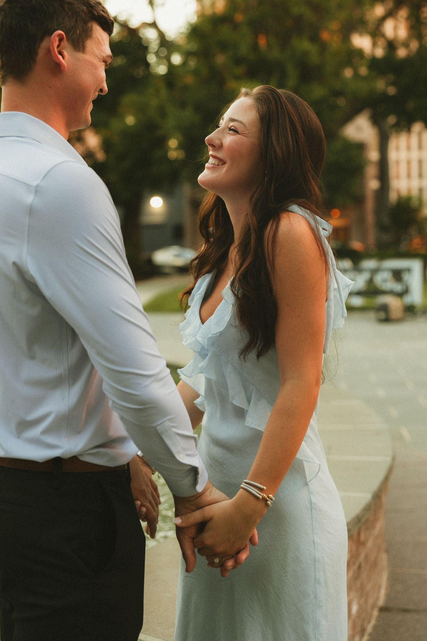 Couple celebrating a surprise proposal in Downtown Mobile, Alabama
