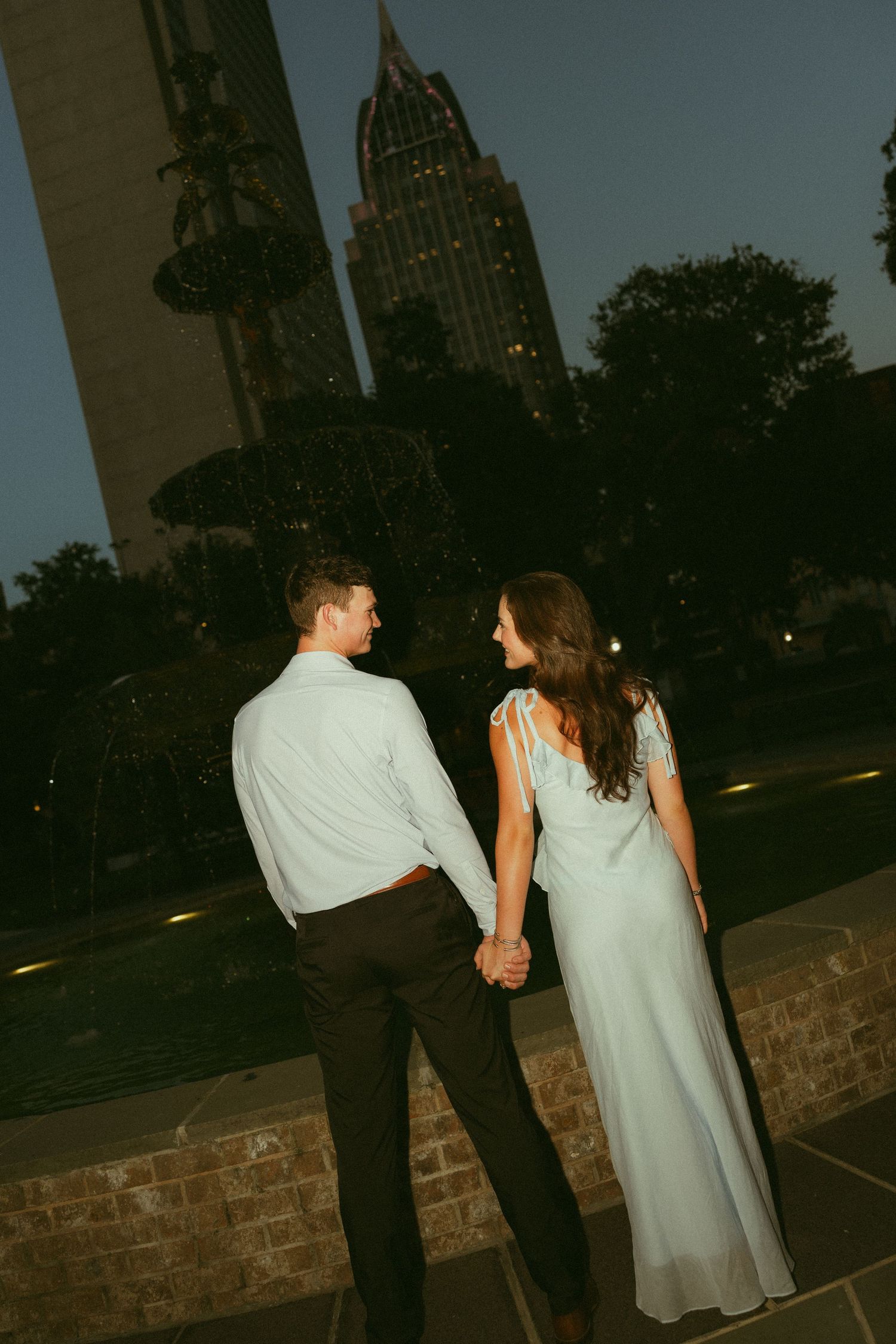 Couple celebrating a surprise proposal in Downtown Mobile, Alabama
