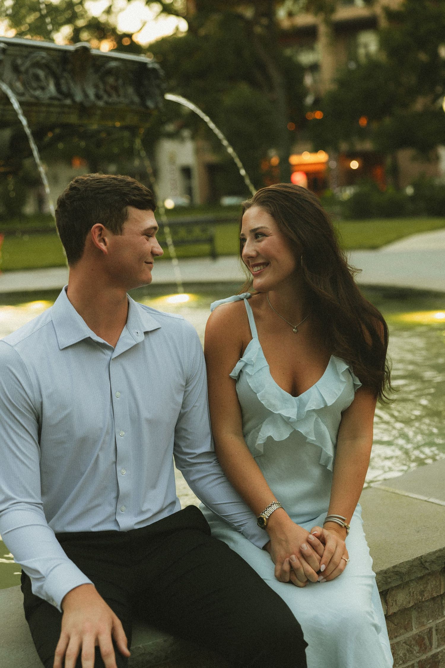 Couple celebrating a surprise proposal in Downtown Mobile, Alabama
