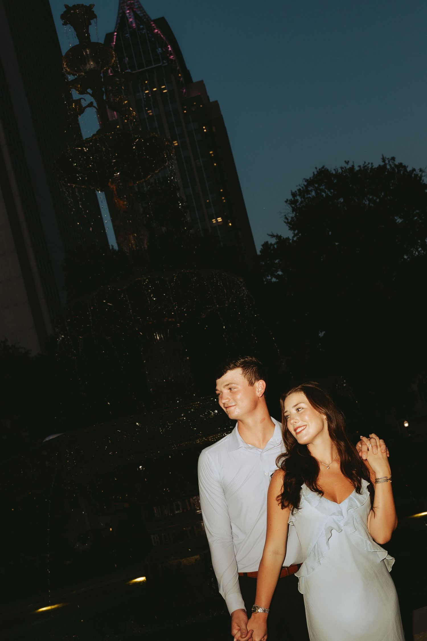 Couple celebrating a surprise proposal in Downtown Mobile, Alabama