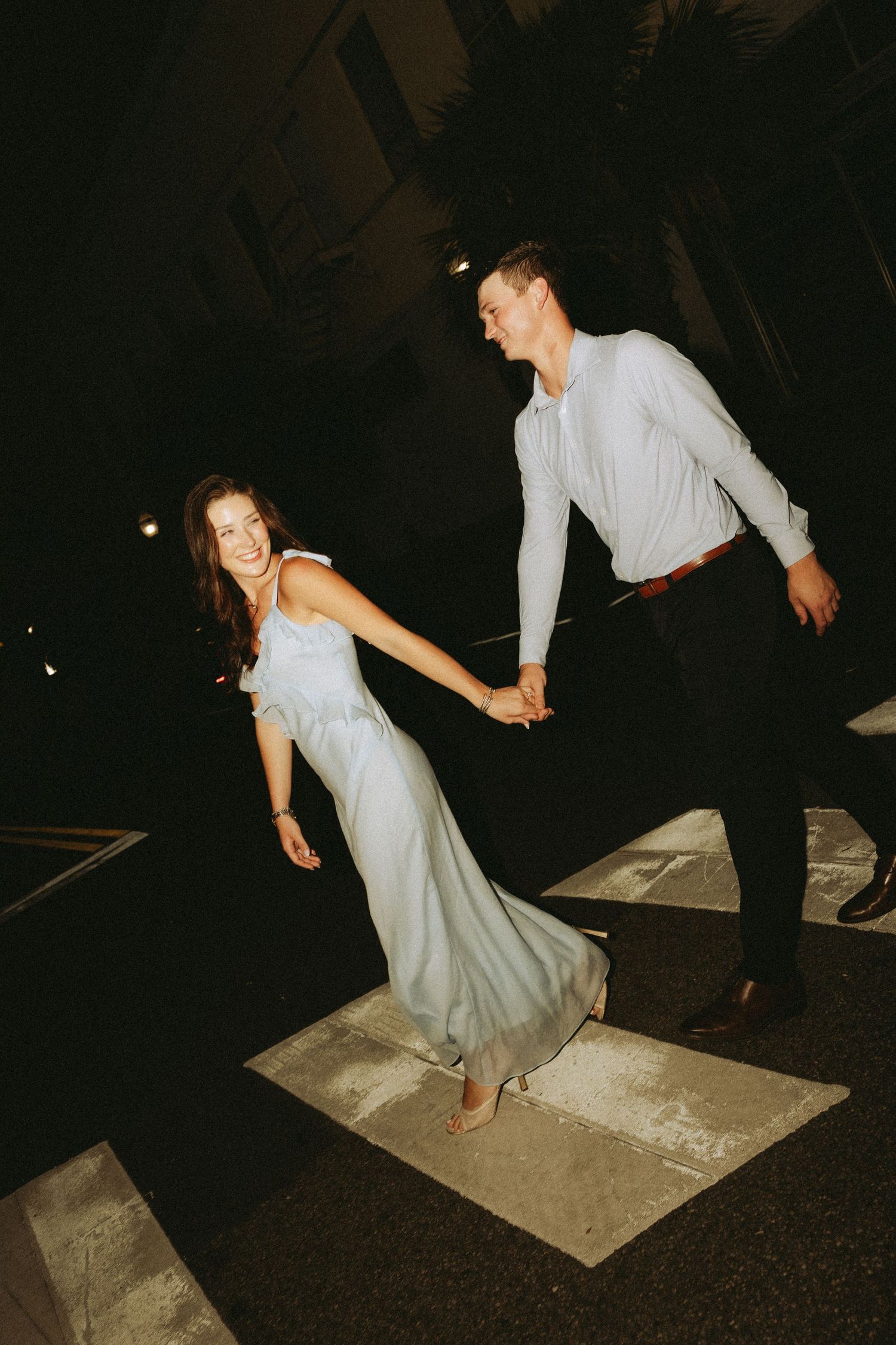 Couple celebrating a surprise proposal in Downtown Mobile, Alabama