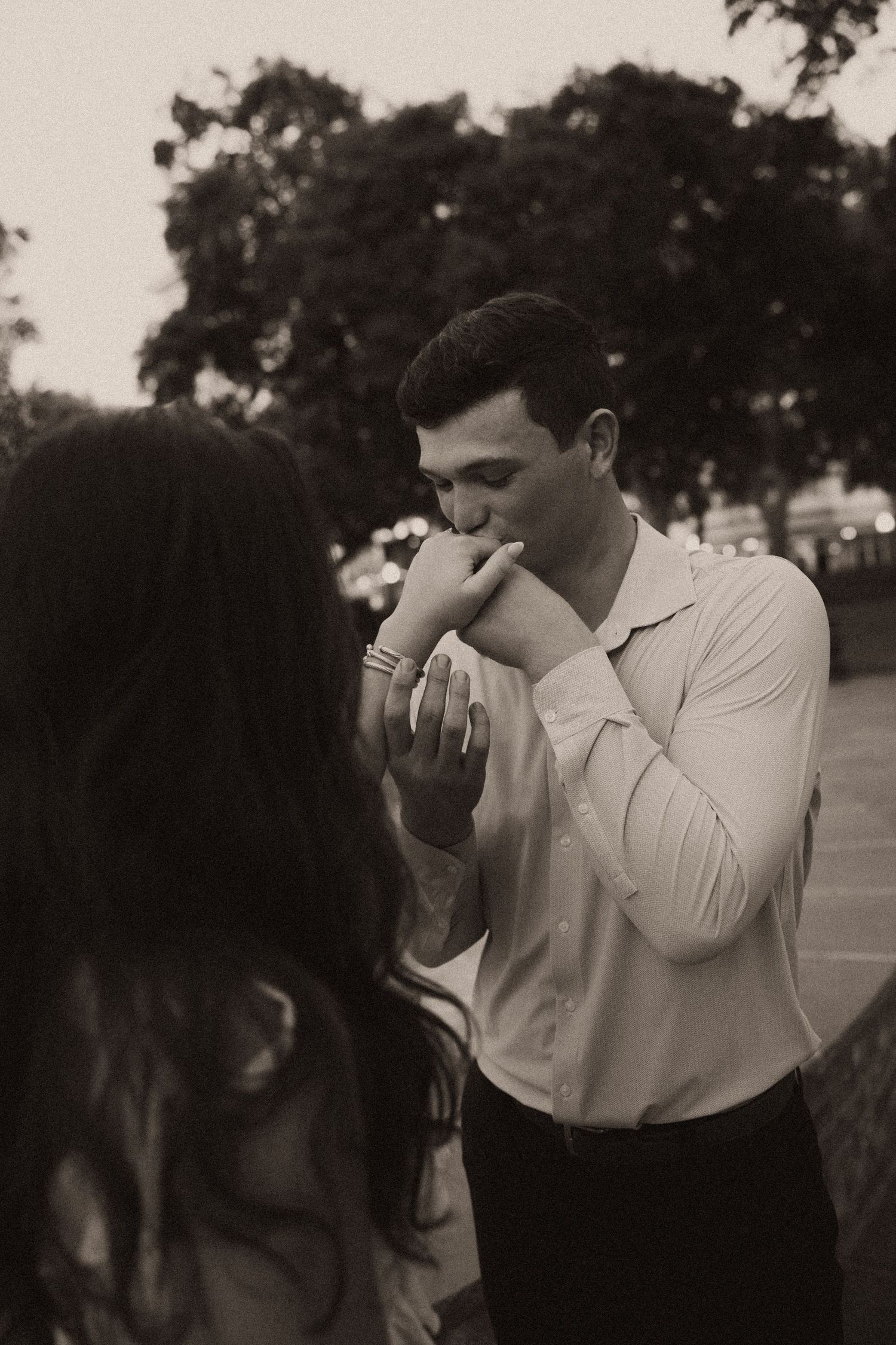 Couple celebrating a surprise proposal in Downtown Mobile, Alabama