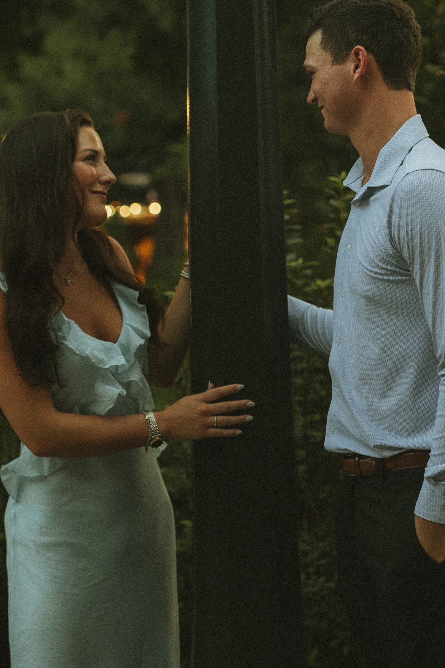 Couple celebrating a surprise proposal in Downtown Mobile, Alabama