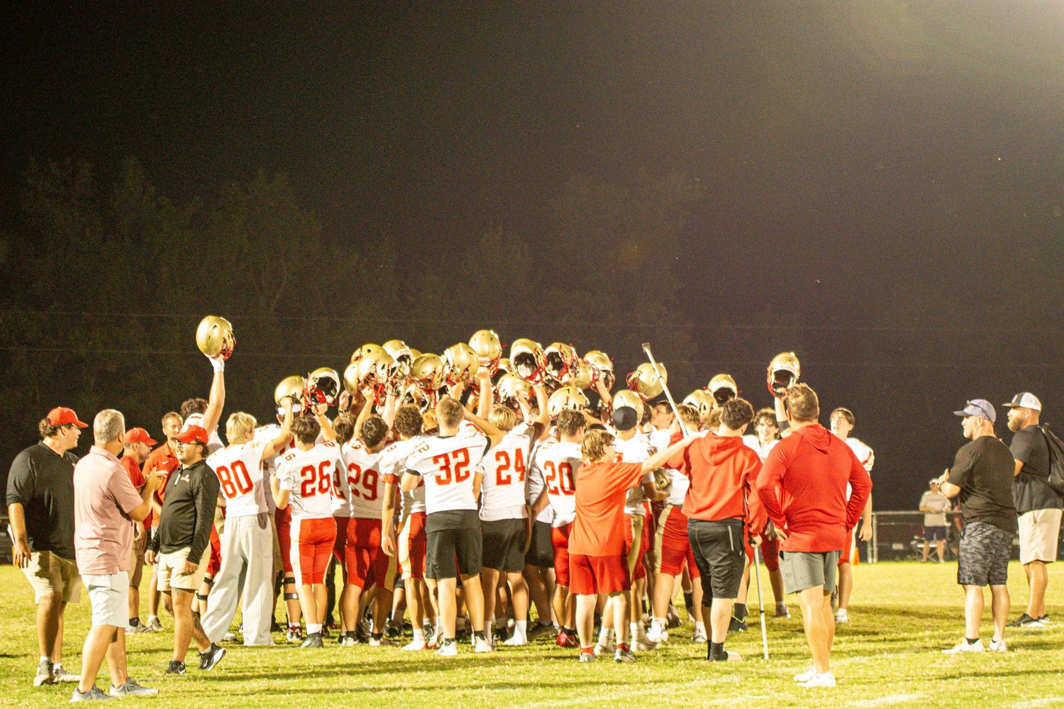 Daniel Boone High School football team huddle during a night game in Gray, Tennessee.