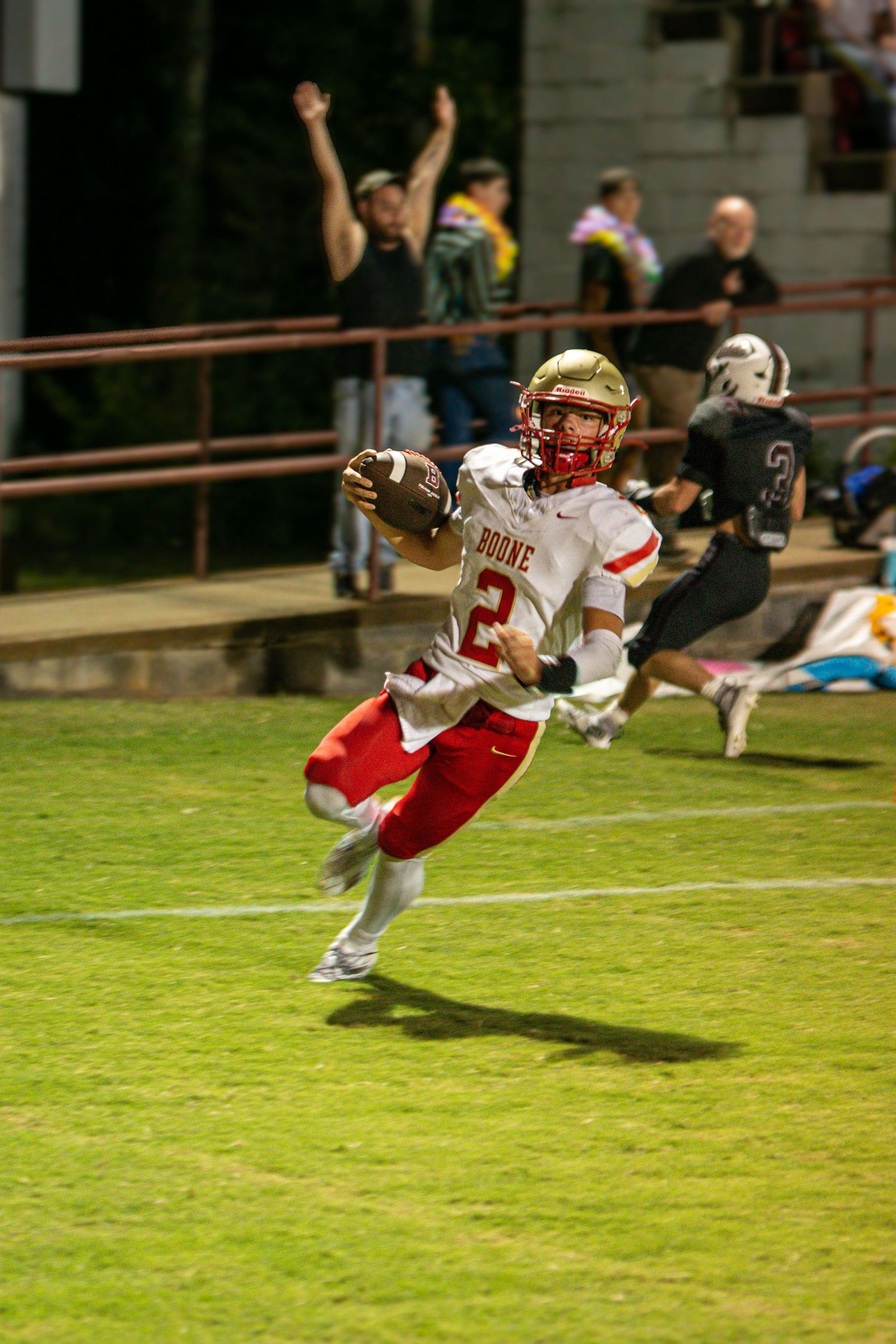 Daniel Boone High School football player running with the ball during a night game in Gray, Tennessee.