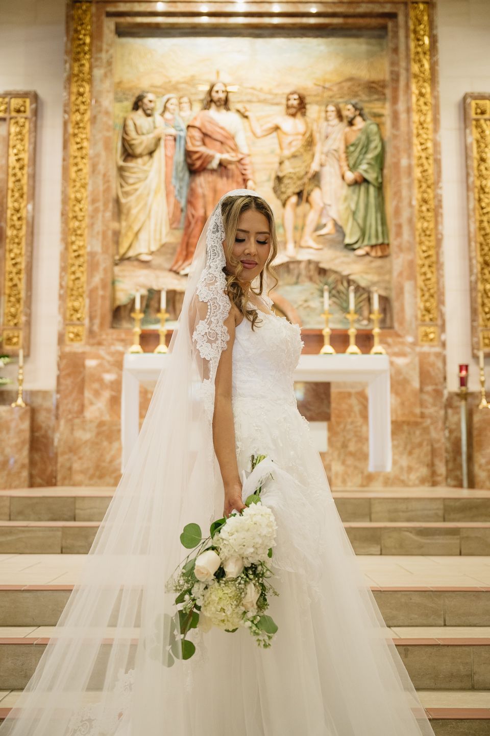 Catholic bride in front of the altar on her wedding day