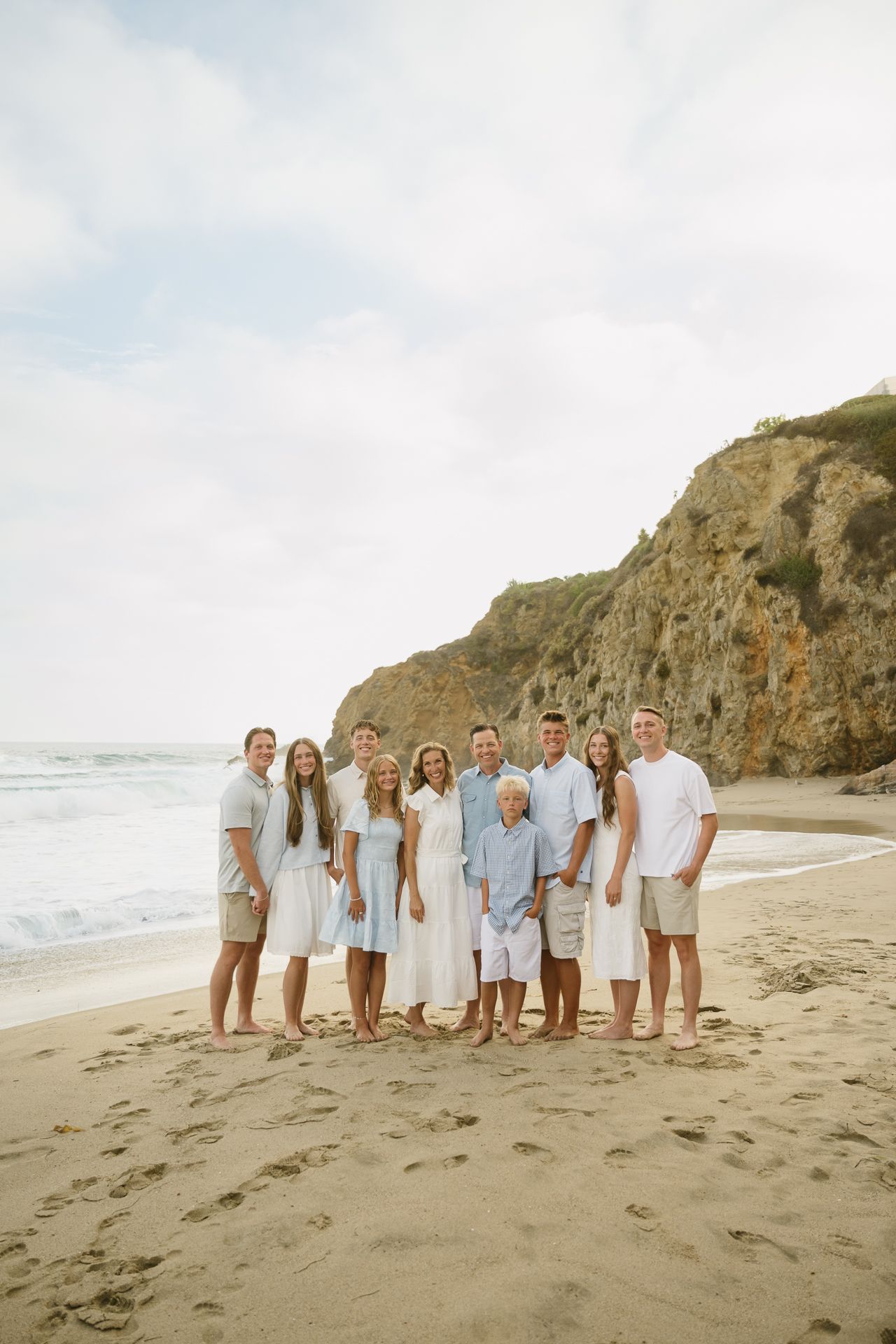 Large family posing together at crescent bay beach in laguna soCal