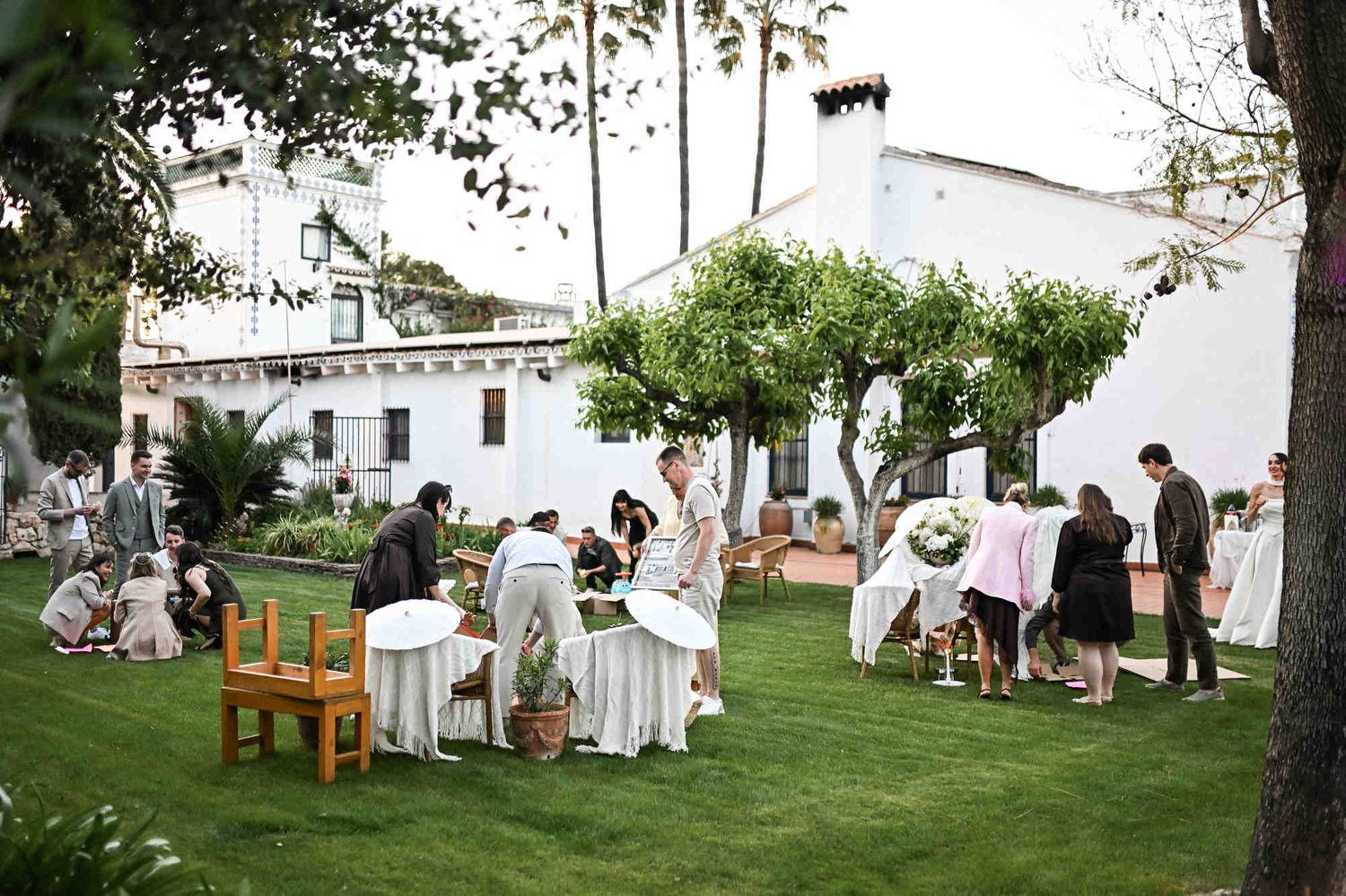 Wedding guests participating in an entertaining house-building game on the lawn at Villa Paula in Valencia.
