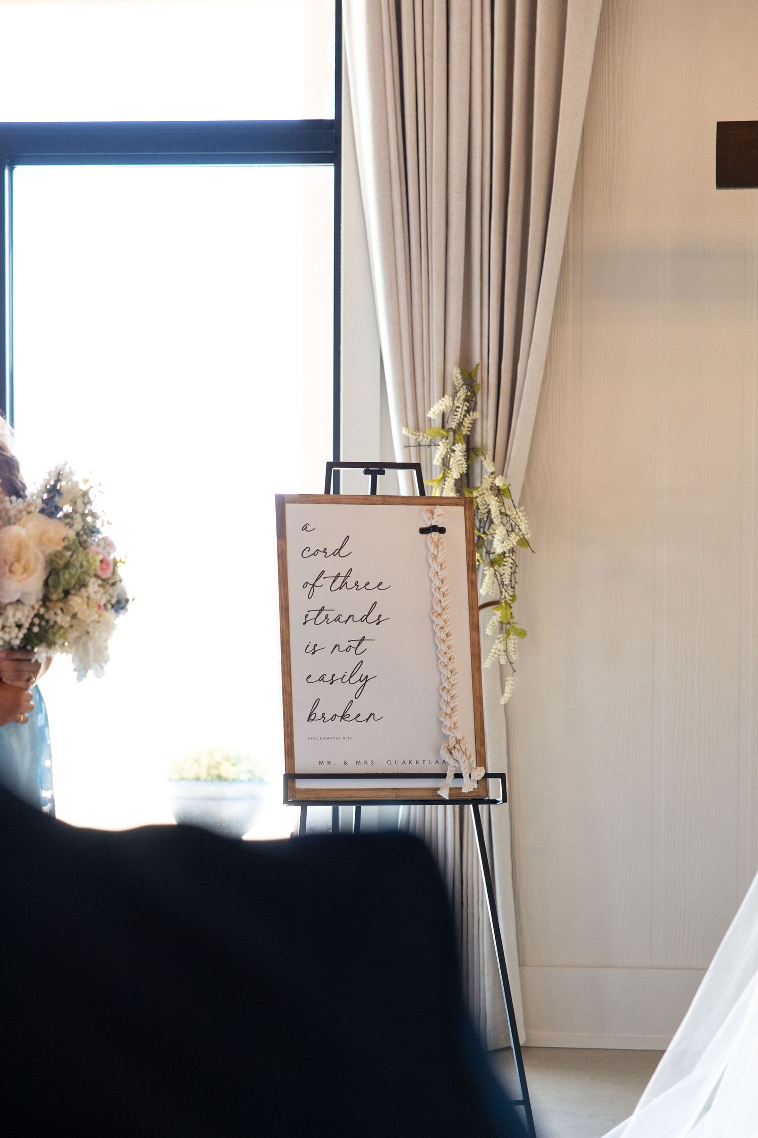 Wedding ceremony sign reading a cord of three strands is not easily broken on easel.