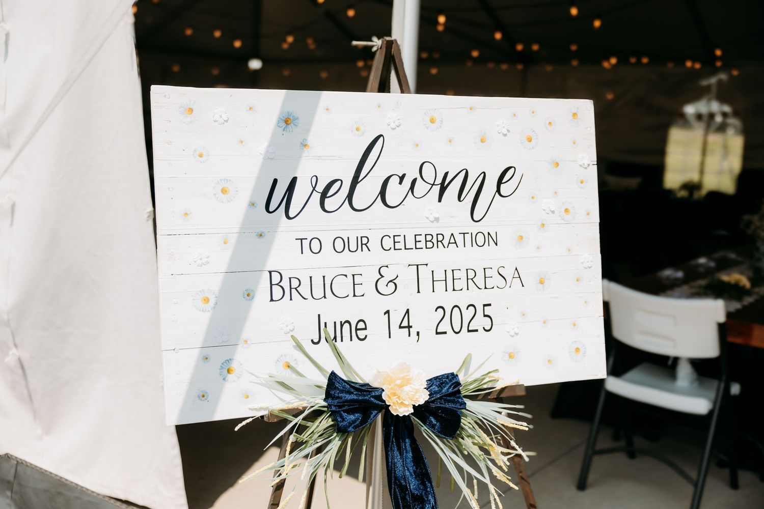 Elegant wedding welcome sign for Bruce and Theresa dated June 14, 2025 decorated with navy bow.