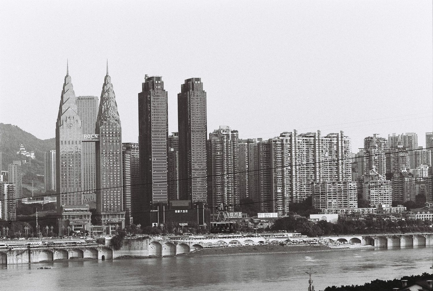 Black and white panoramic view of Chongqing skyline along the Yangtze River.