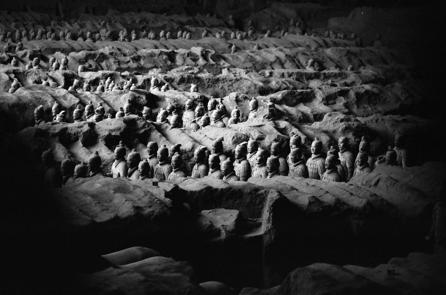 Black and white aerial view of the Terracotta Army warriors in their excavation pit in Xian.