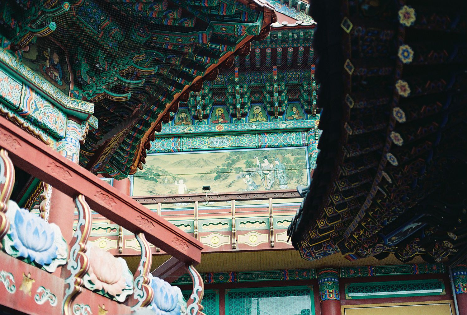 Vibrant colorful eaves of a traditional Korean Buddhist temple with intricate painted decorations.