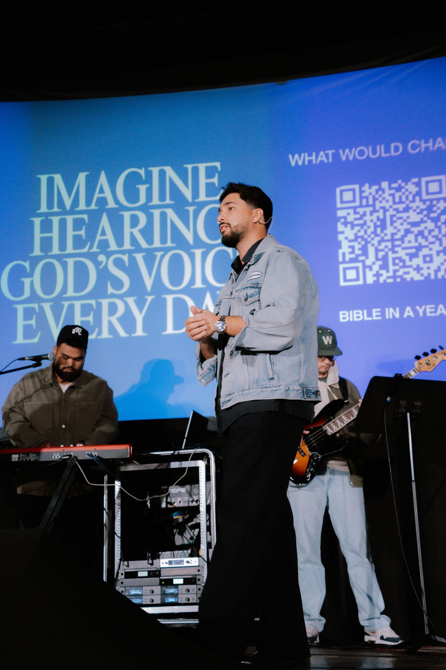 Church speaker Kyle Howeth presenting on stage during a live service with creative visuals in the background