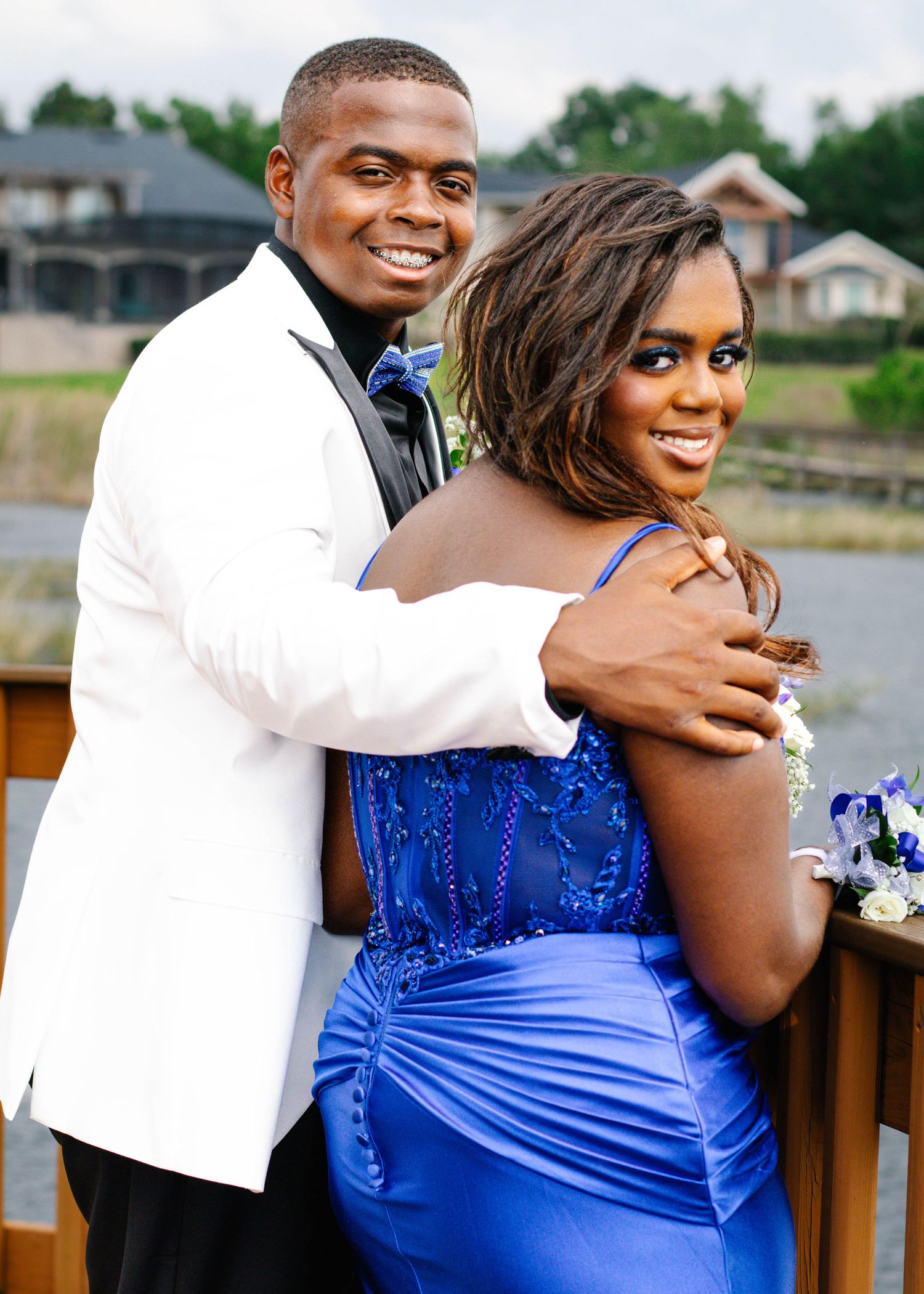 High school senior couple posing together for prom photos during an outdoor photography session