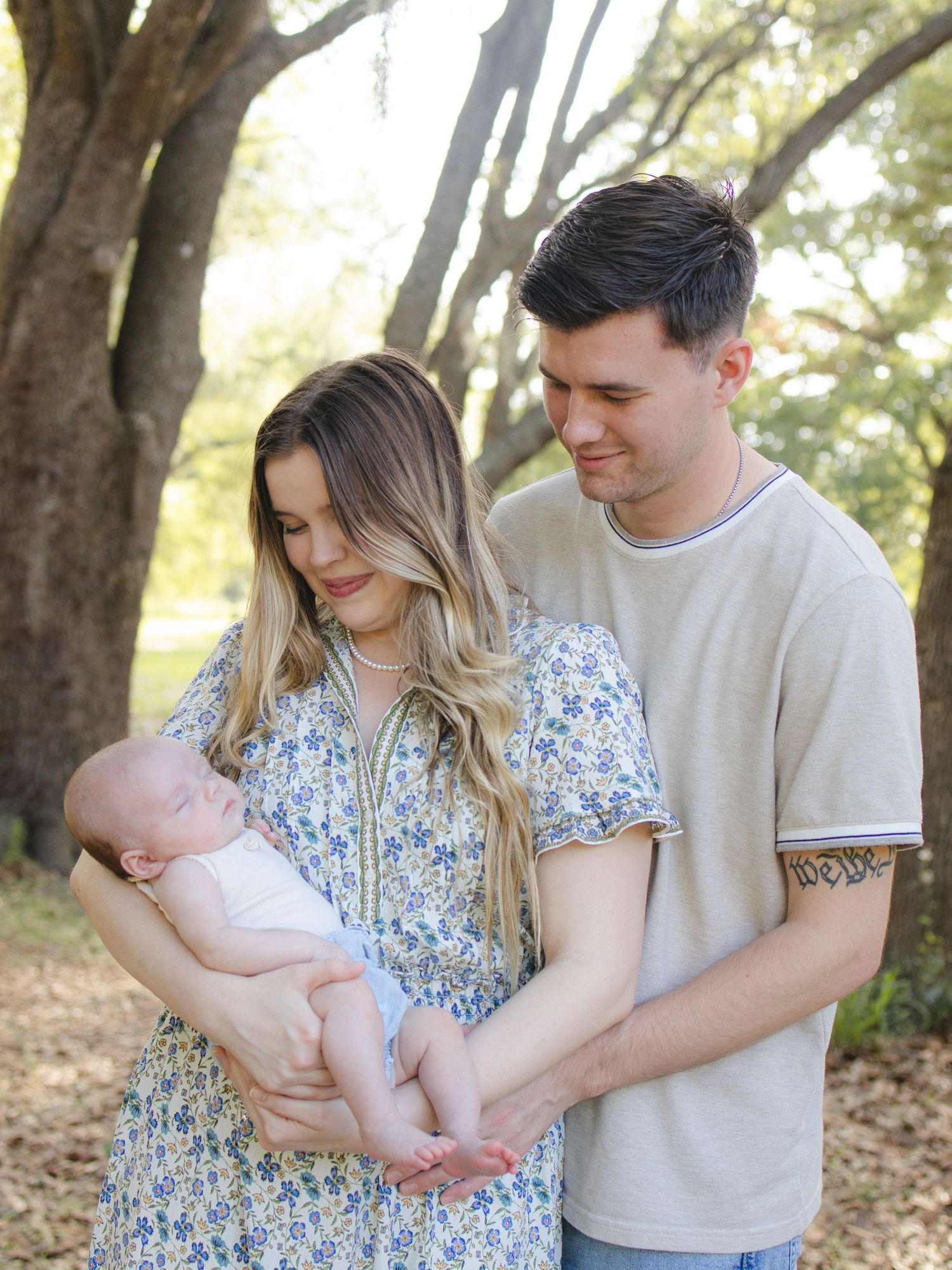Parents looking lovingly at their baby during an outdoor family photography session