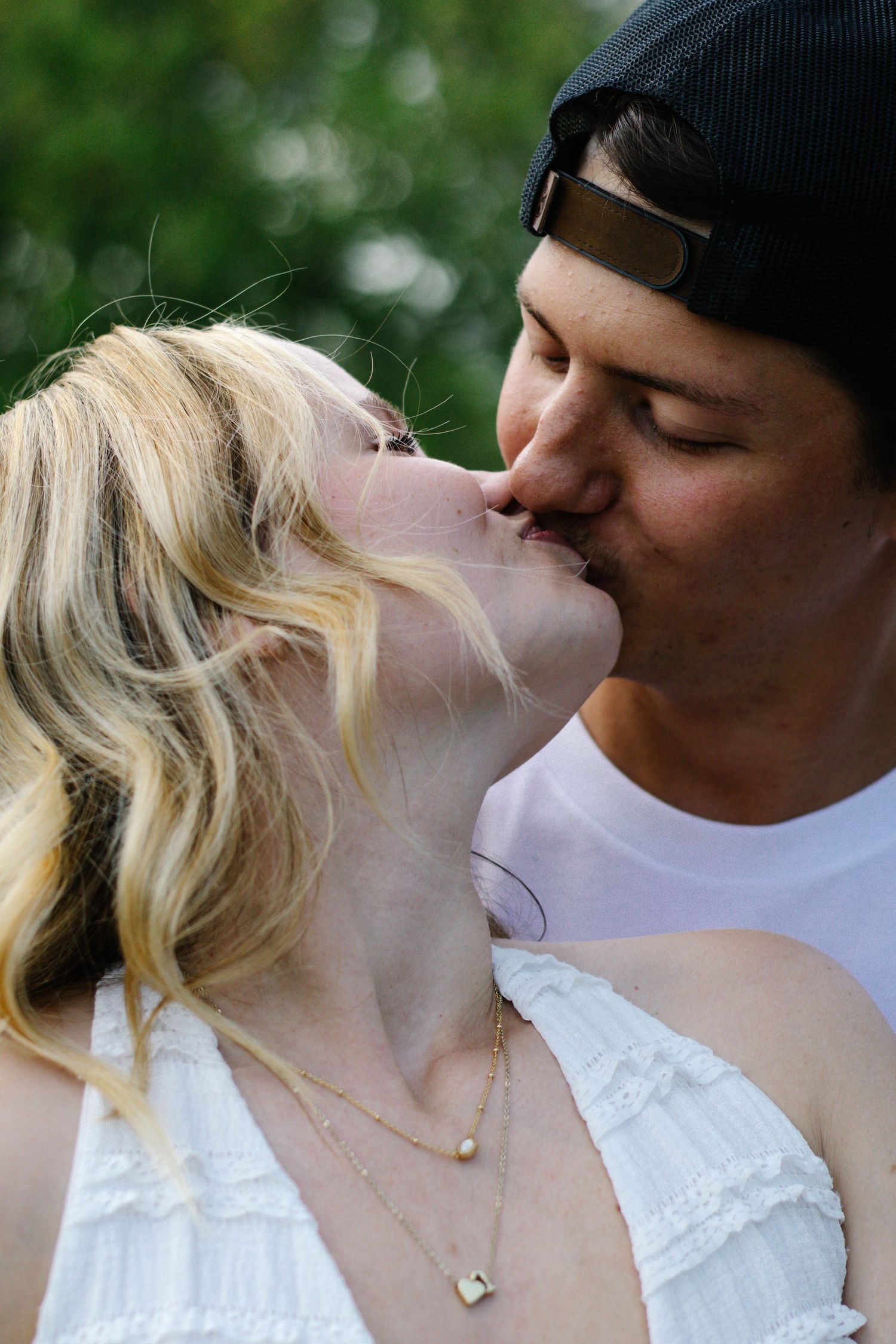 Close-up detail of a couple kissing during an outdoor photography session