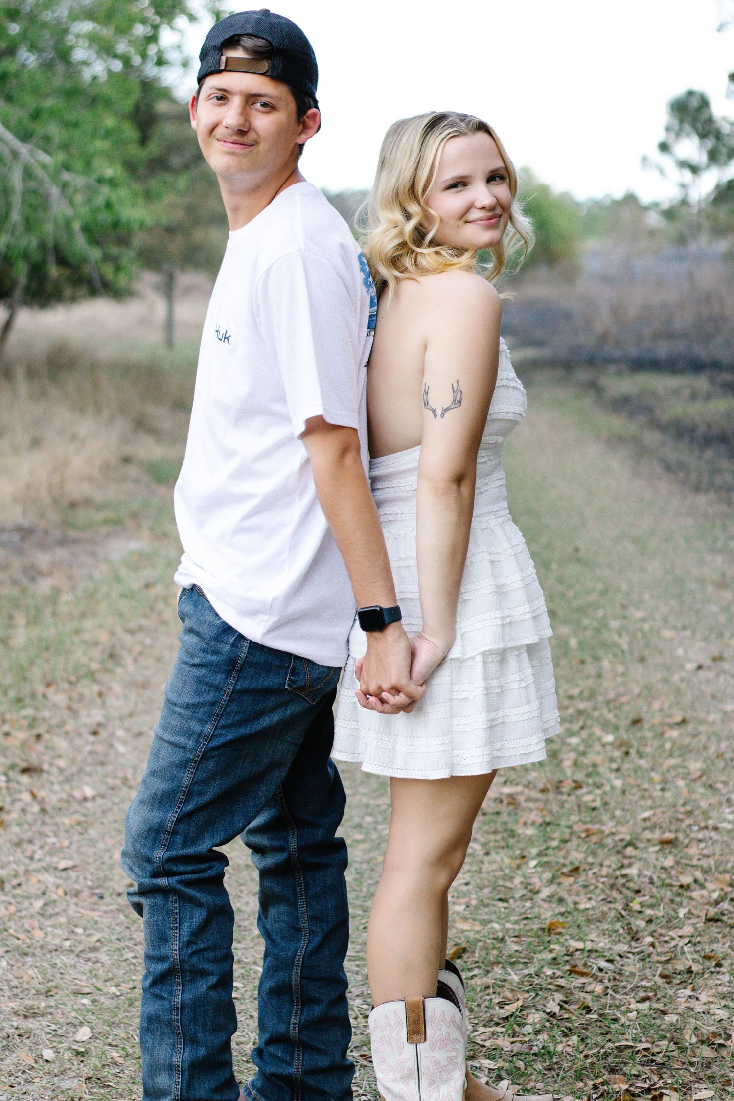 Couple standing back to back during an outdoor photography session