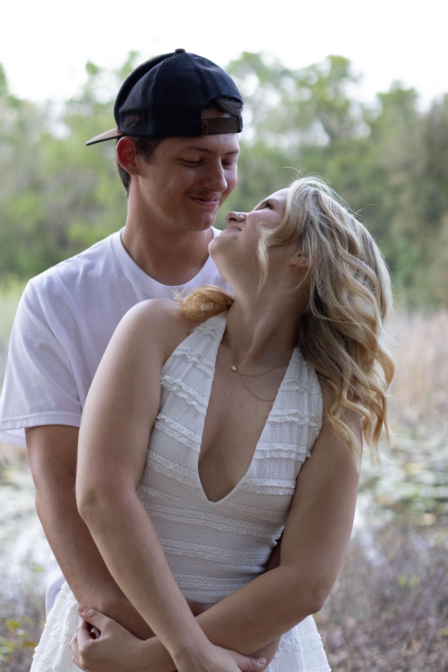 Couple holding each other and looking into each other’s eyes during an outdoor photography session