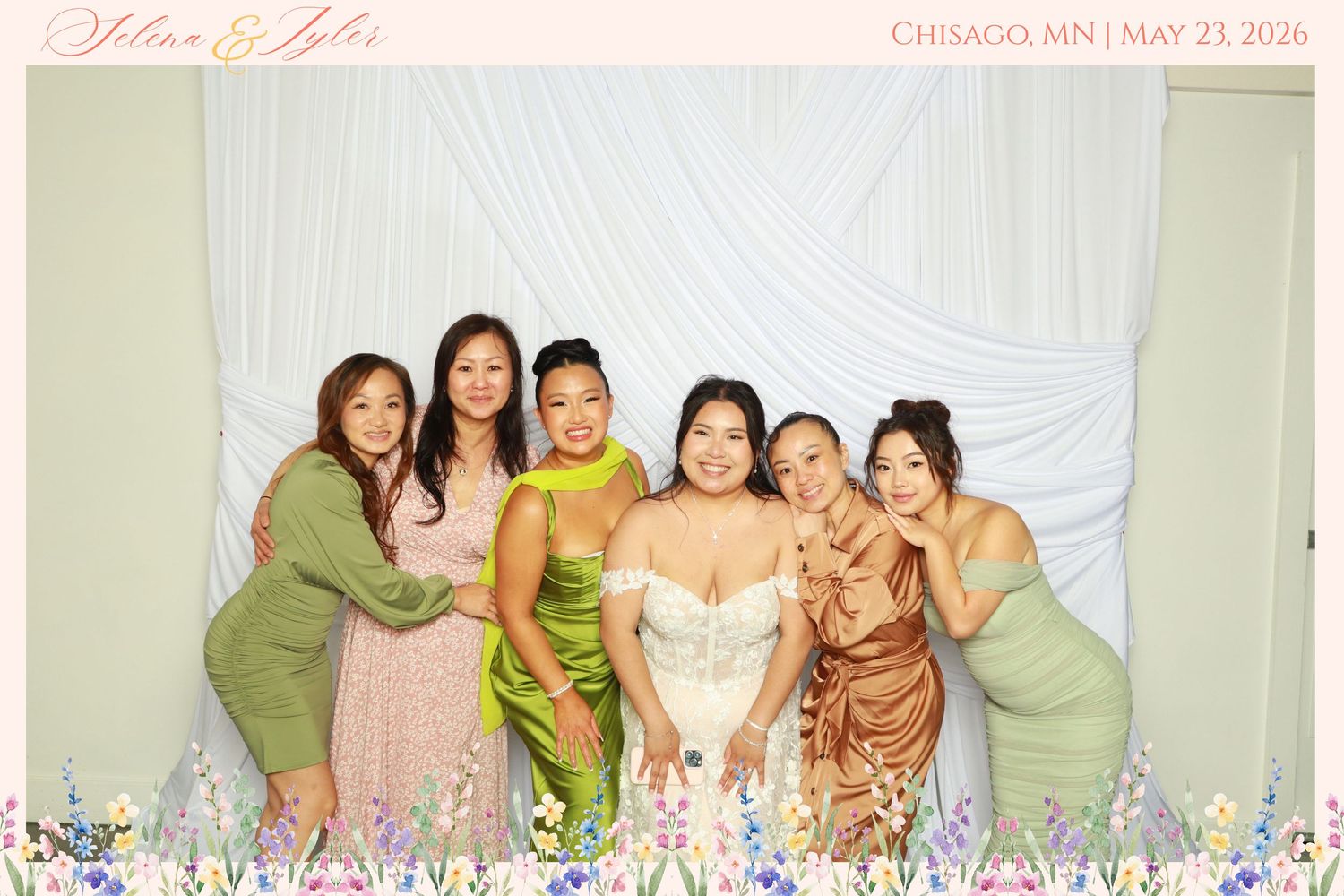 Wedding photo booth picture for Selena & Tyler, Chisago MN May 23 2026, showing bride with five bridesmaids in colorful gowns.