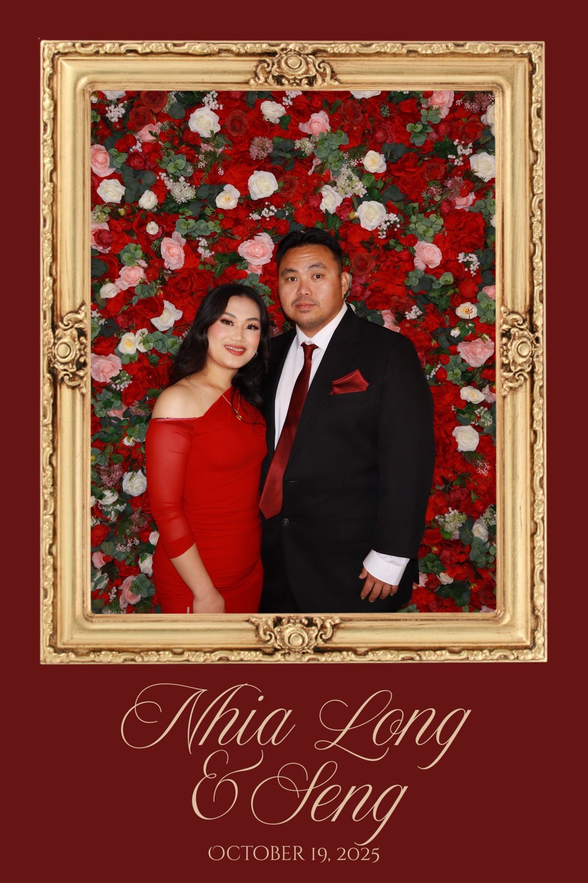 Couple poses in front of red floral wall in gold frame at Nhia Long & Seng wedding on October 19, 2025.
