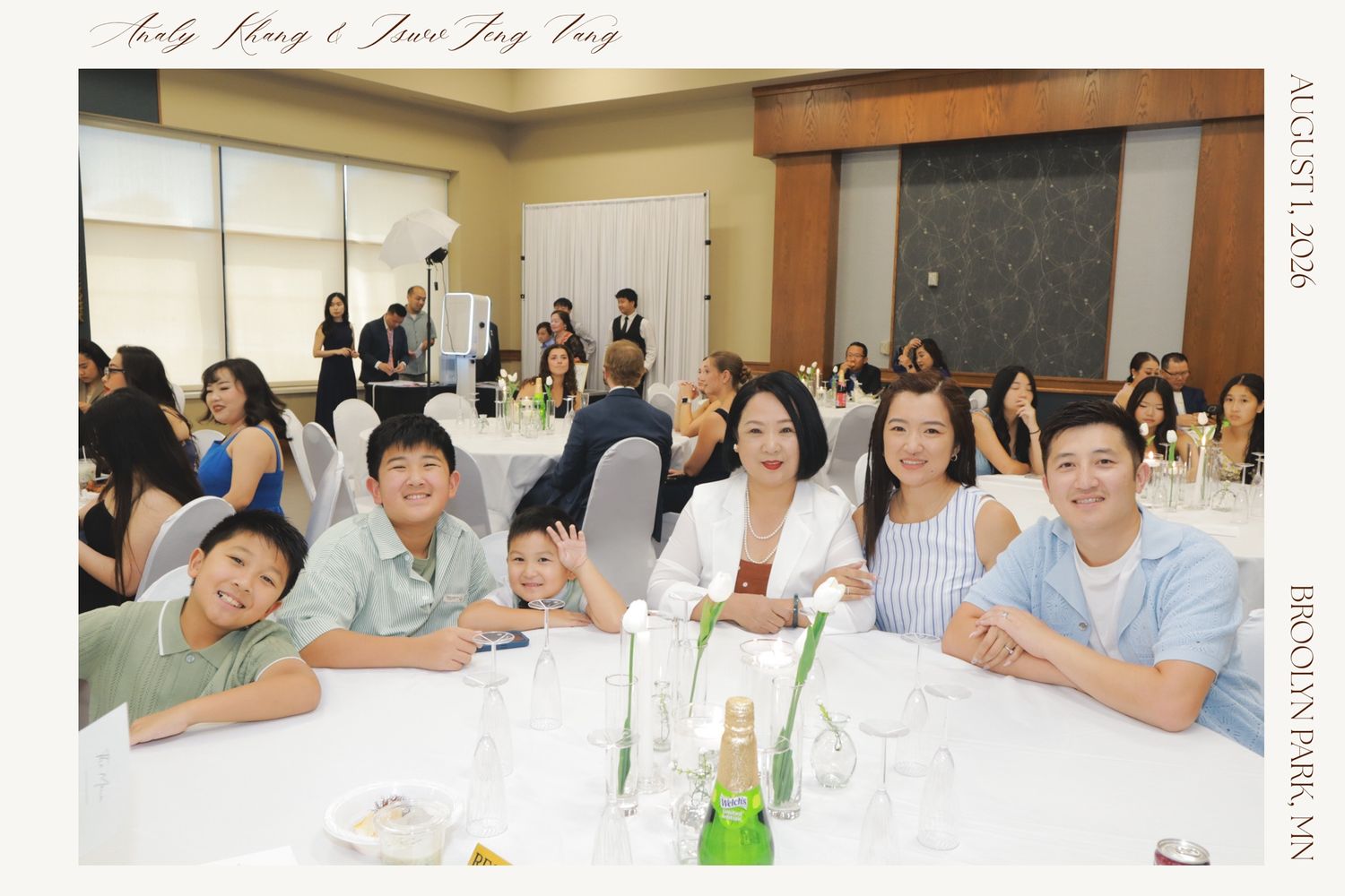 Group of smiling family members seated at a round table during a formal banquet celebration event.