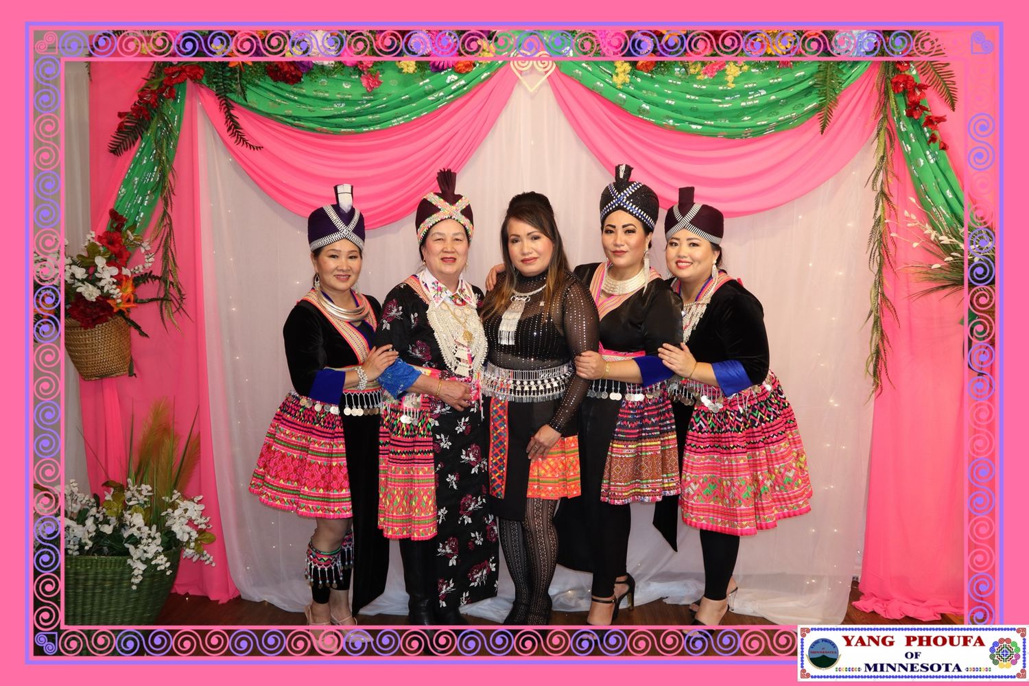 Five women in traditional Hmong clothing posing together at Yang PhouFa New Year event in Minnesota.