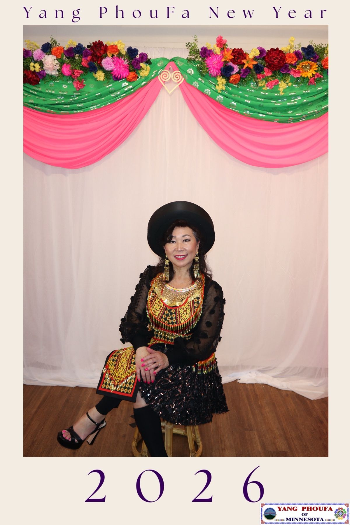 Woman in traditional embroidered outfit and black hat posing at Yang PhouFa New Year 2026 celebration in Minnesota.