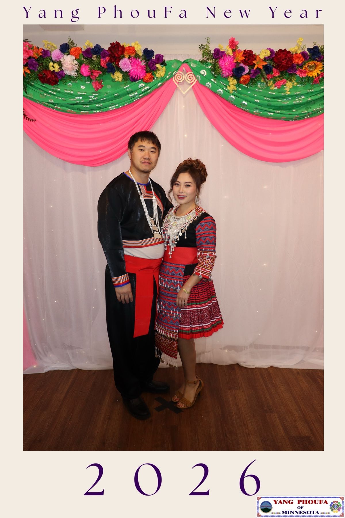 Couple in traditional Hmong attire posing at Yang PhouFa New Year 2026 celebration in Minnesota.