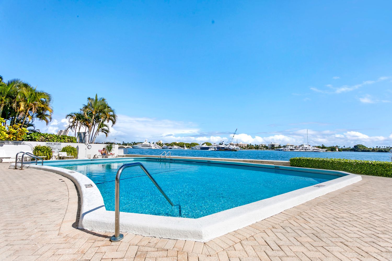 Serene infinity pool overlooking a tranquil marina with sailboats Professional real estate photography in Palm Bech,
brodiganphotograpy.com