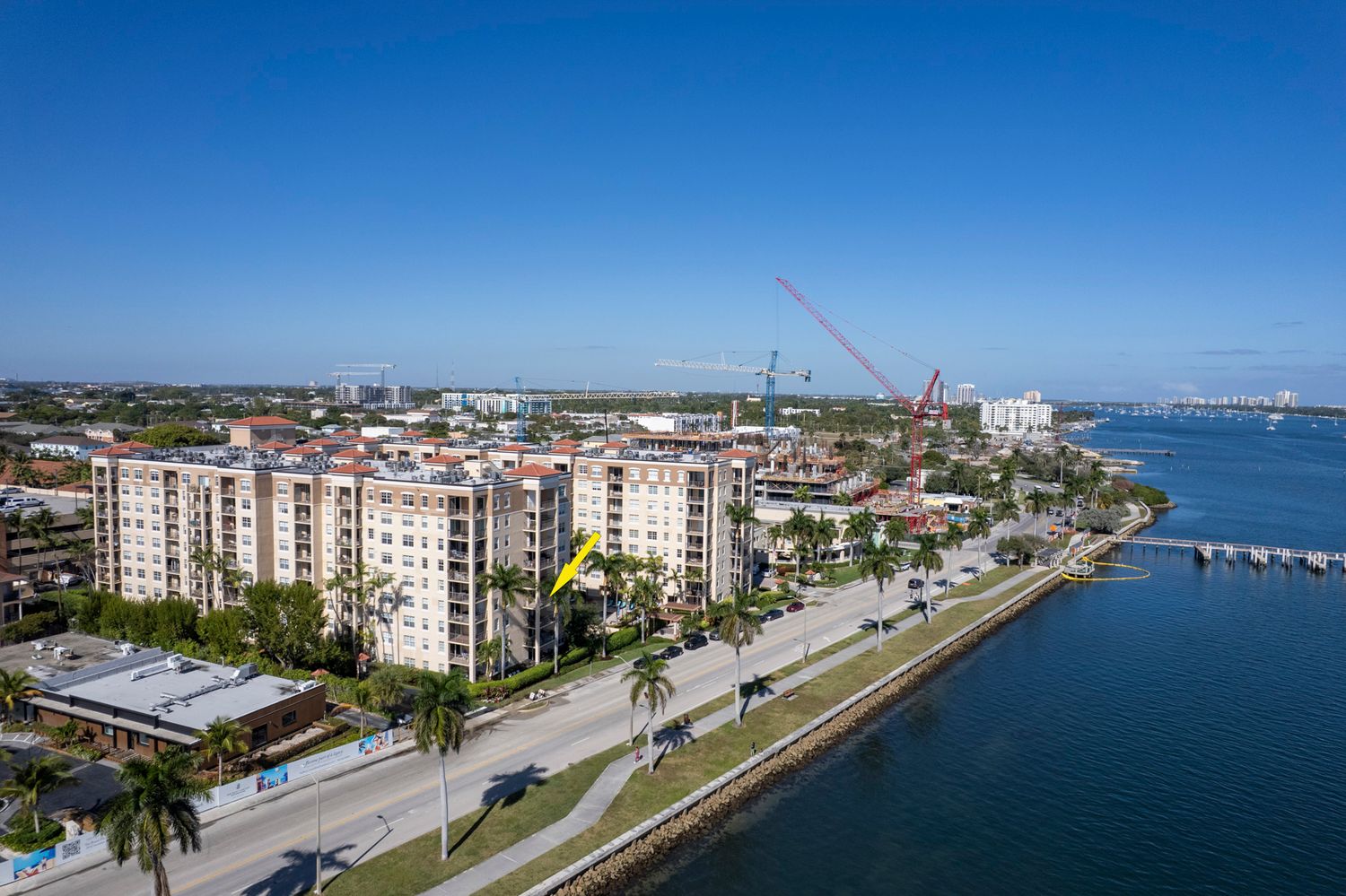 Aerial view of luxury waterfront high-rise condos and construction cranes along a west Palm Beach coastline by brodigan photography.com