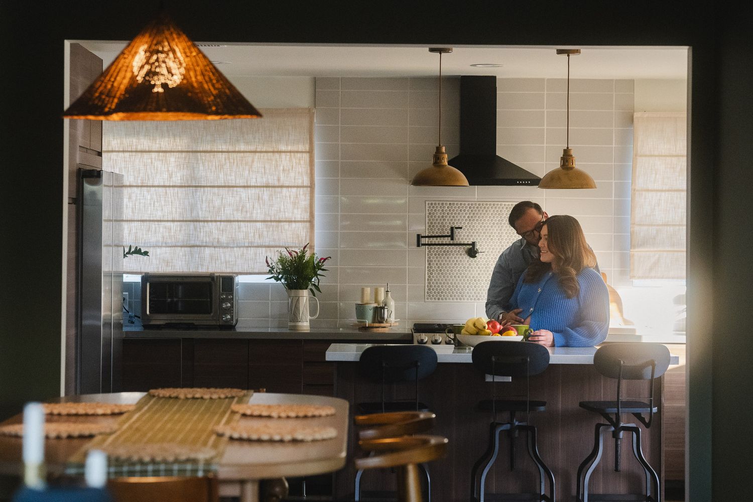 Amanda and Rohan standing together in their kitchen during an at home maternity photoshoot in Pasadena