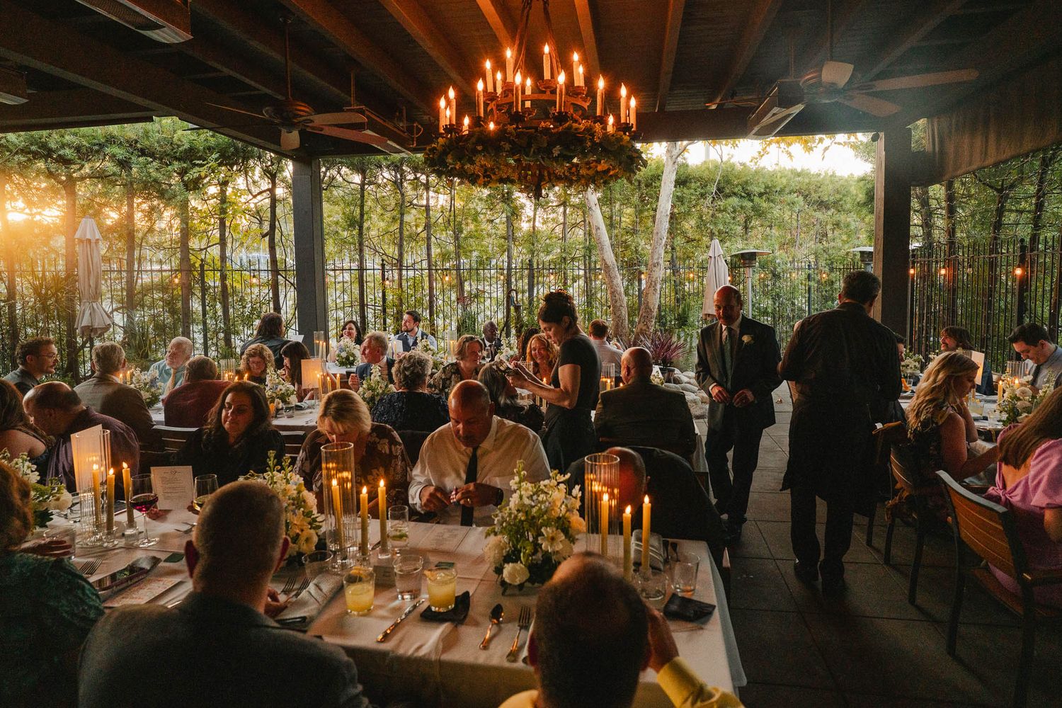 Candid reception moment from a Pasadena wedding dinner captured in warm evening light