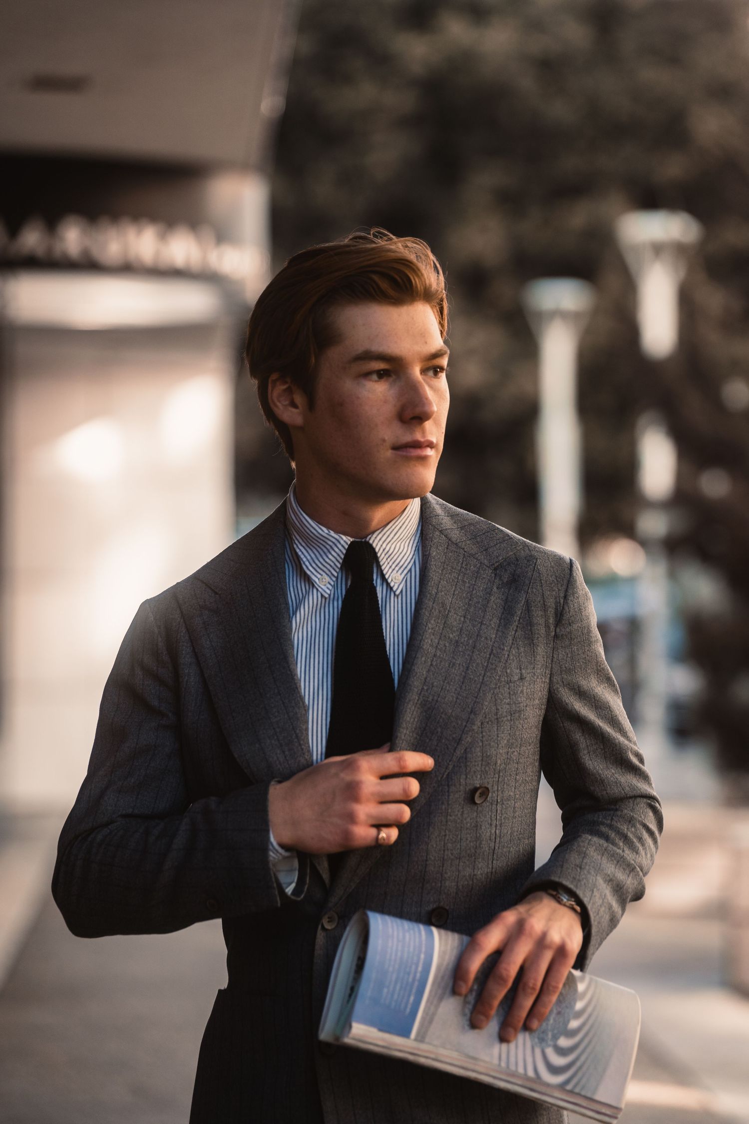 Editorial-style photo of a male model walking in Little Tokyo, Los Angeles, highlighting classic and timeless imagery.