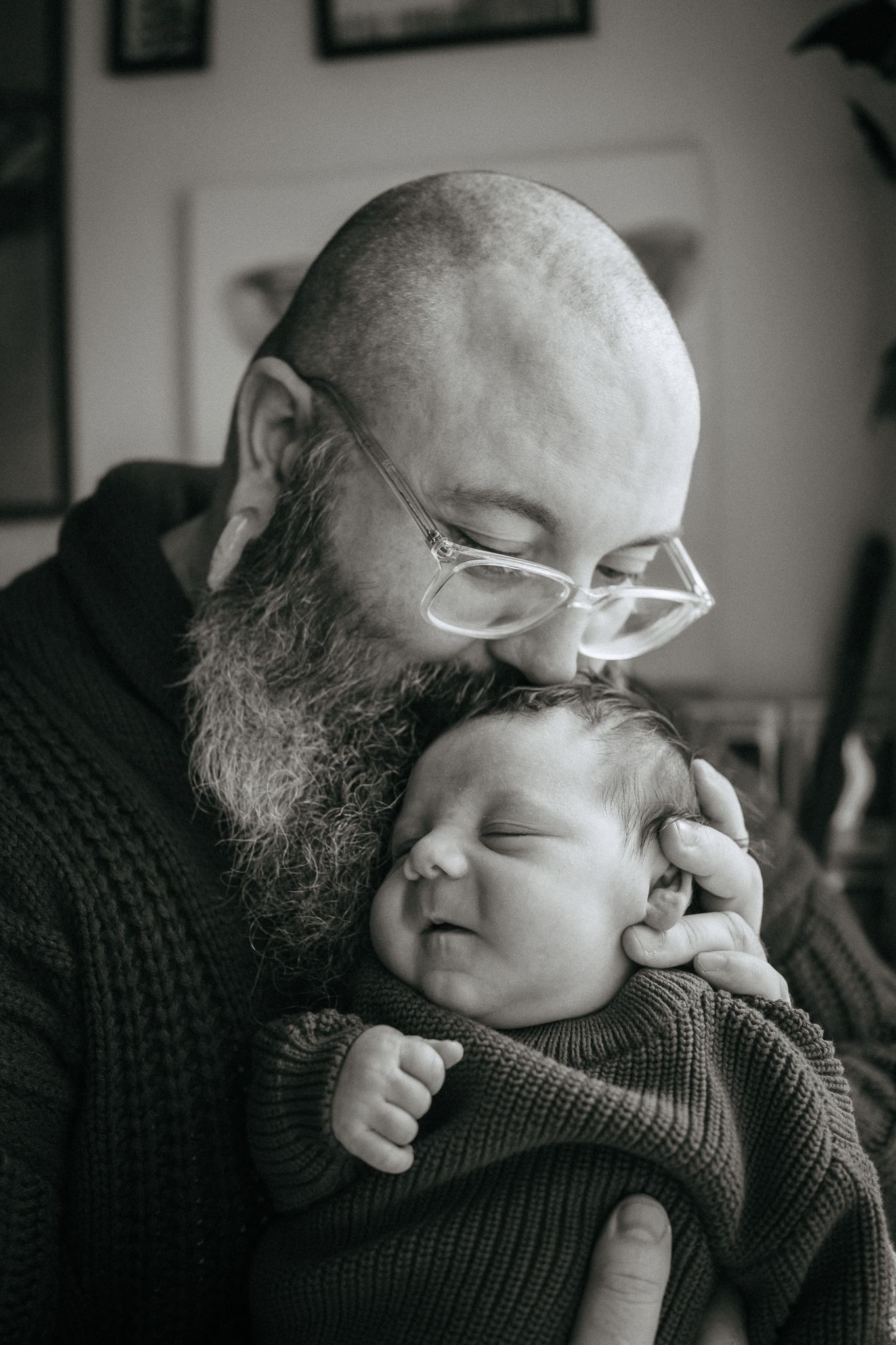 Intimate black and white portraits showing tender moments with a baby.