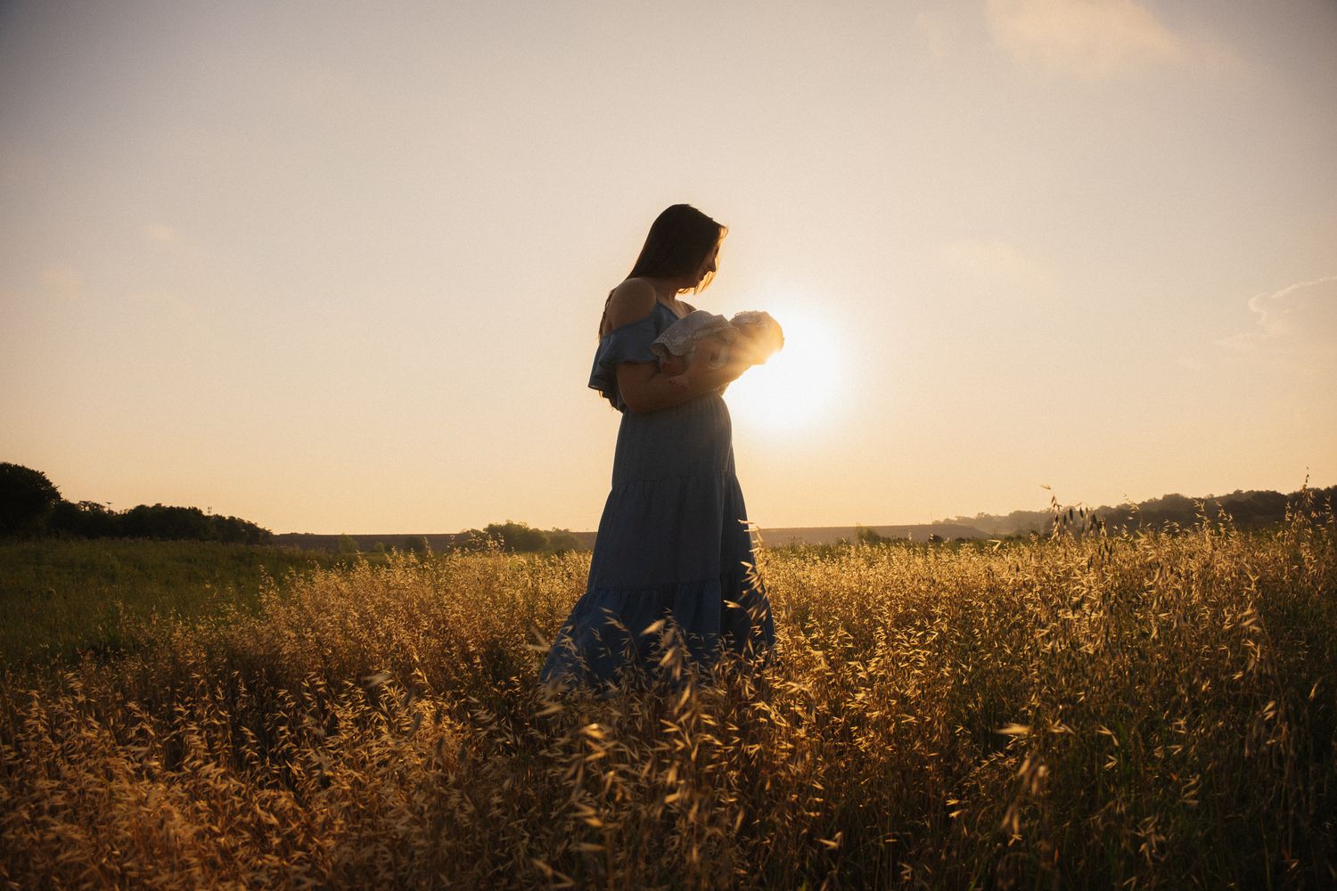 Mother during a newborn photoshoot in Austin with soft natural light