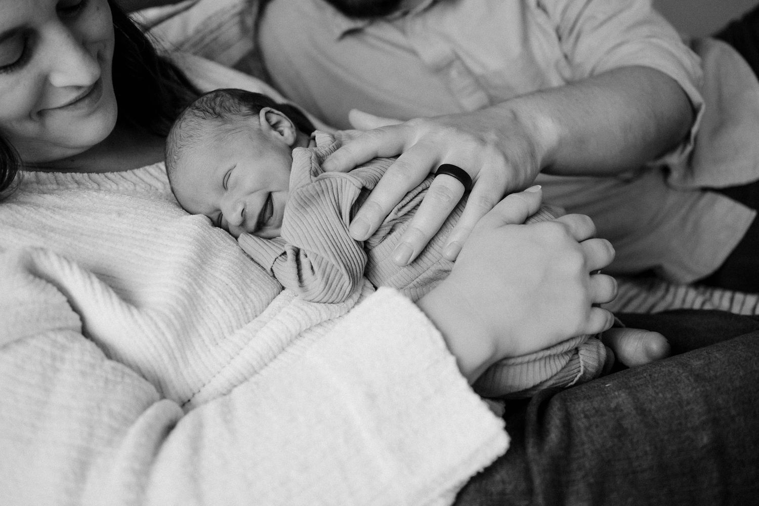 Black and white photo collage showing tender moments between parents and newborn babies in hospital settings.